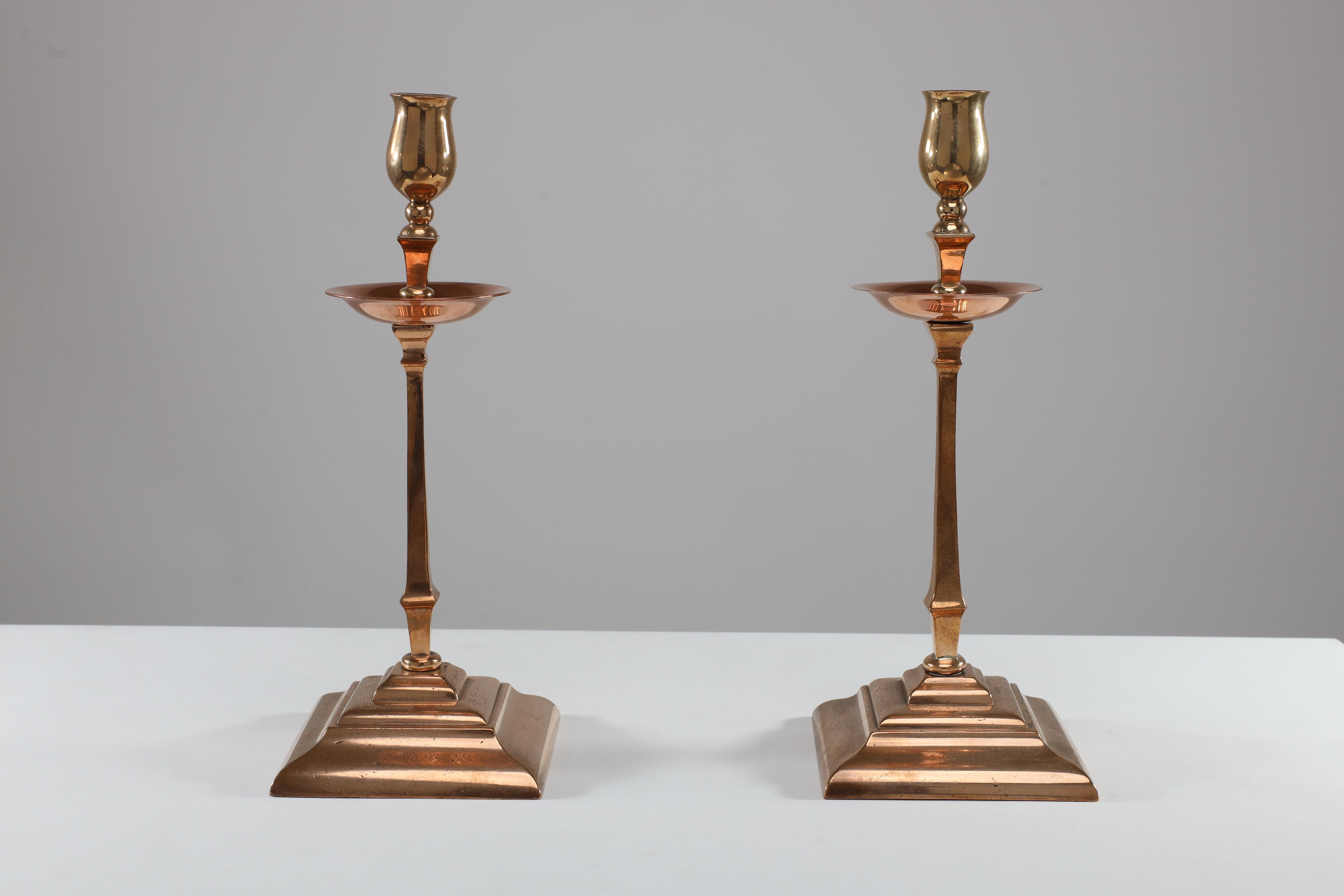 English WAS Benson. A pair of Arts and Crafts brass and copper candlesticks For Sale