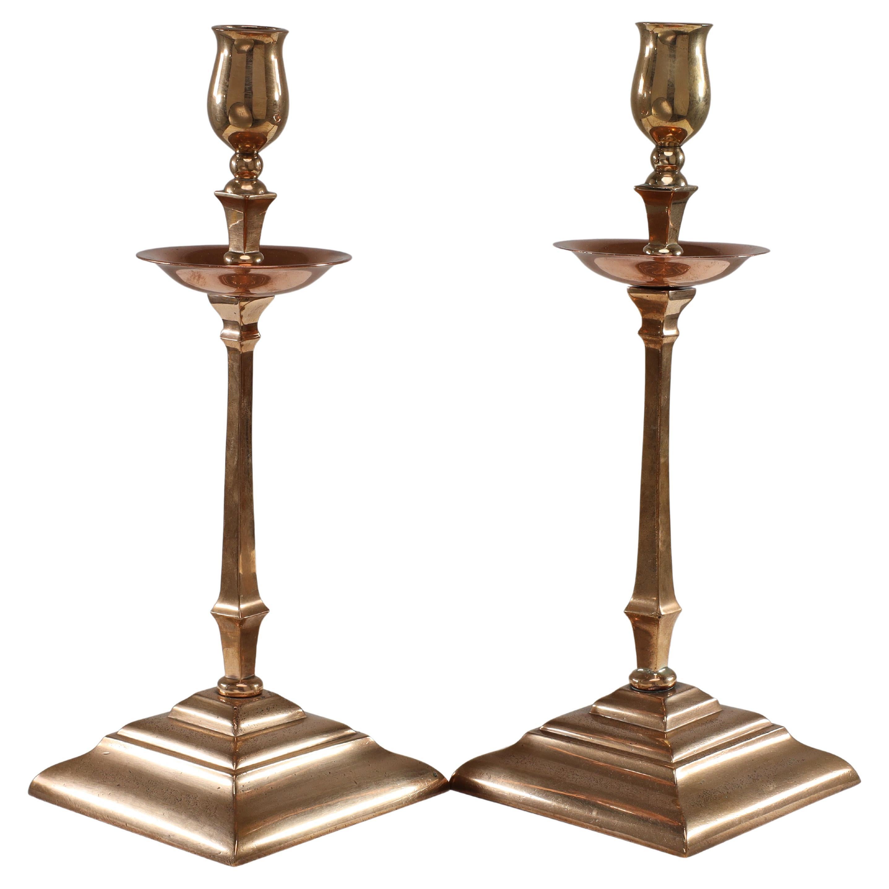 WAS Benson. A pair of Arts and Crafts brass and copper candlesticks