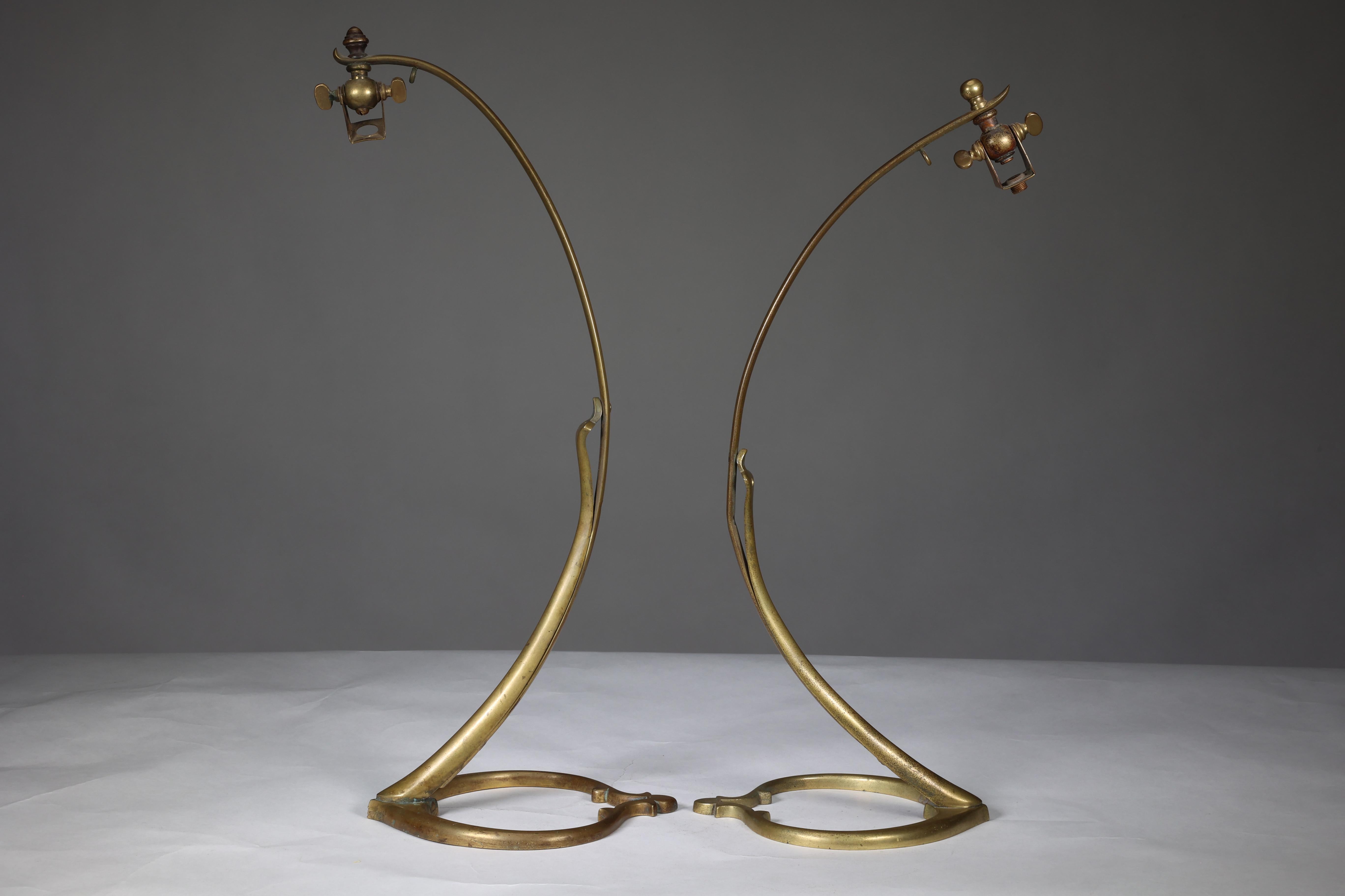 W A S Benson. A near pair of Arts and Crafts brass swan style table lamps with heart shaped bases. WAS Benson Catalogue plate 15, illustration No 1079. We will send enough antique style cable and two lamp holders for your electrician to wire for