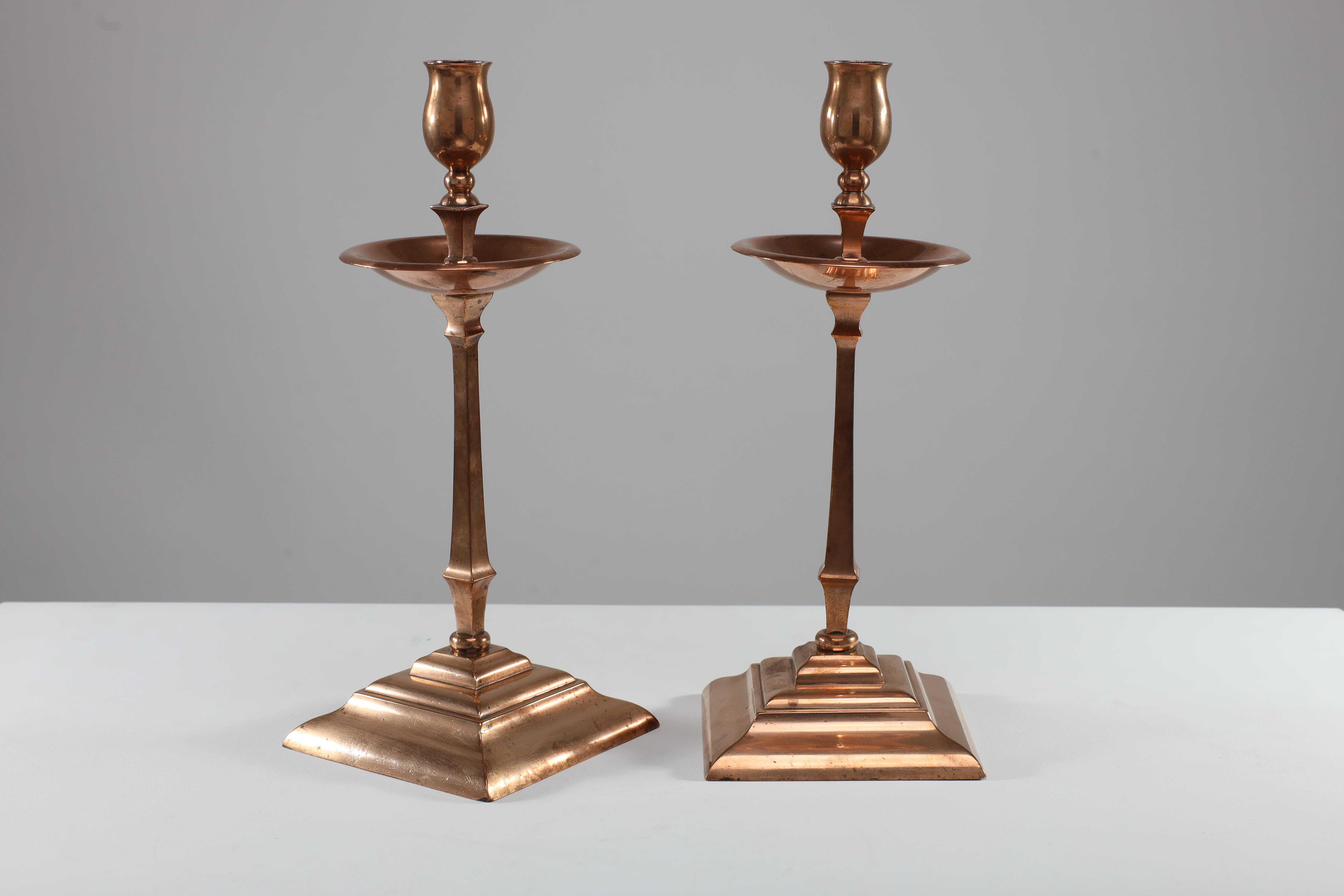 W A S Benson. A pair of Arts and Crafts copper and brass candlesticks. Price for the pair.