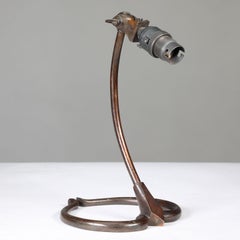 WAS Benson. A patinated brass swan table light with heart shaped base
