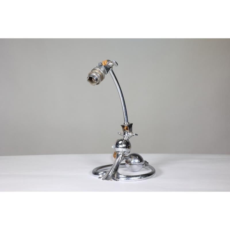 W A S Benson. An Arts and Crafts chrome plated table lamp with a heart-shaped base and counter balance weighted ball. 
Replaced switch. WAS Benson Catalogue number E1293.
