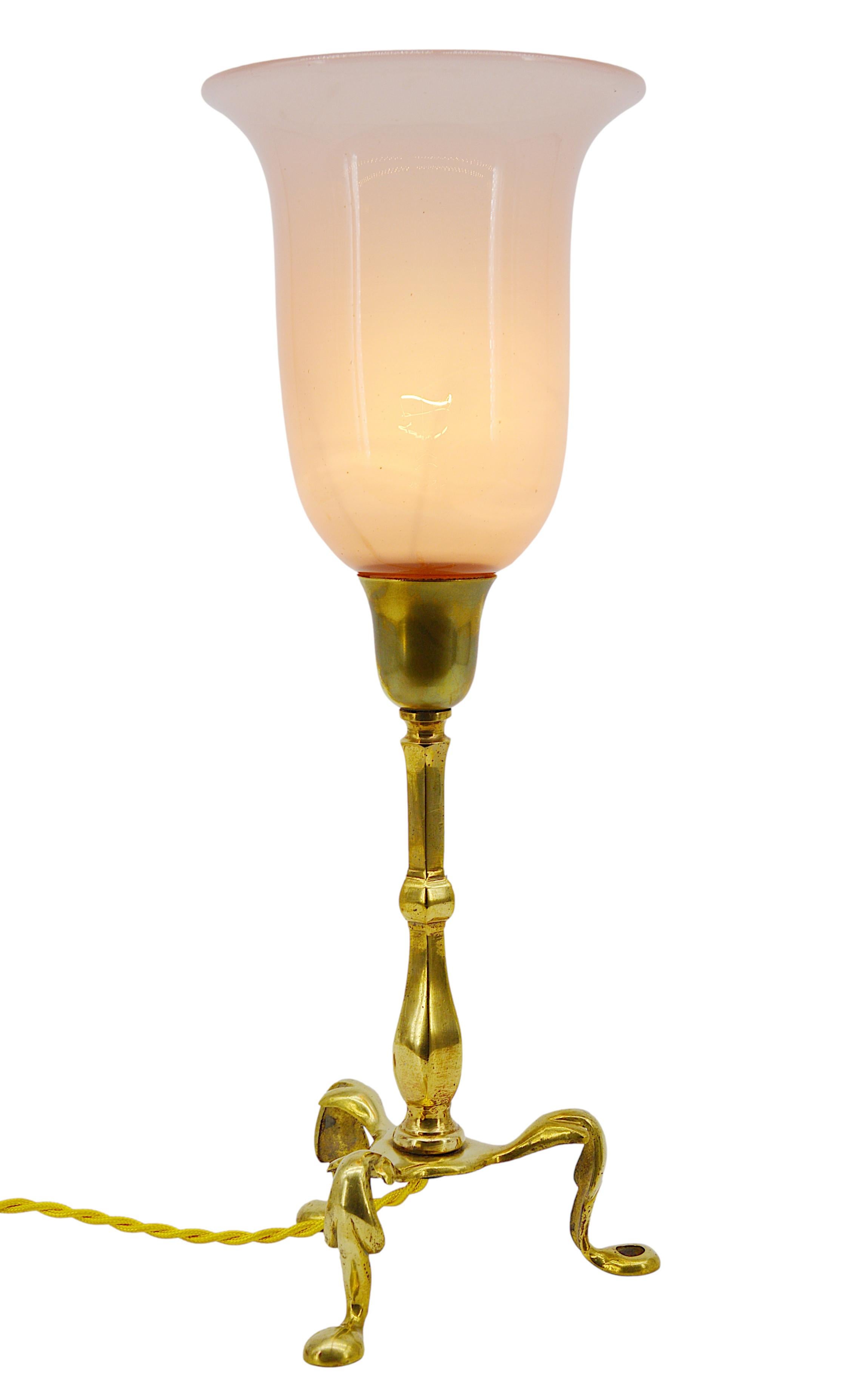Pair of antique table lamps or wall sconces attributed to William Arthur Smith Benson, England, ca. 1900. Opaline glass and brass. Fine shades in opalin pink glass. Brass fixtures. Can be used as table lamps or wall sconces, a hole on a branch to