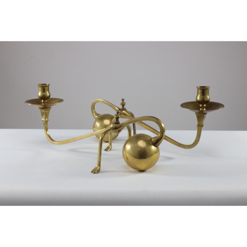 In the style of W A S Benson. A pair of brass Arts & Crafts counter-weighted piano candle holders. These are Spanish and very much in the style of W A S Benson. Originally designed to sit on top of a piano leaning over the edge to illuminate the