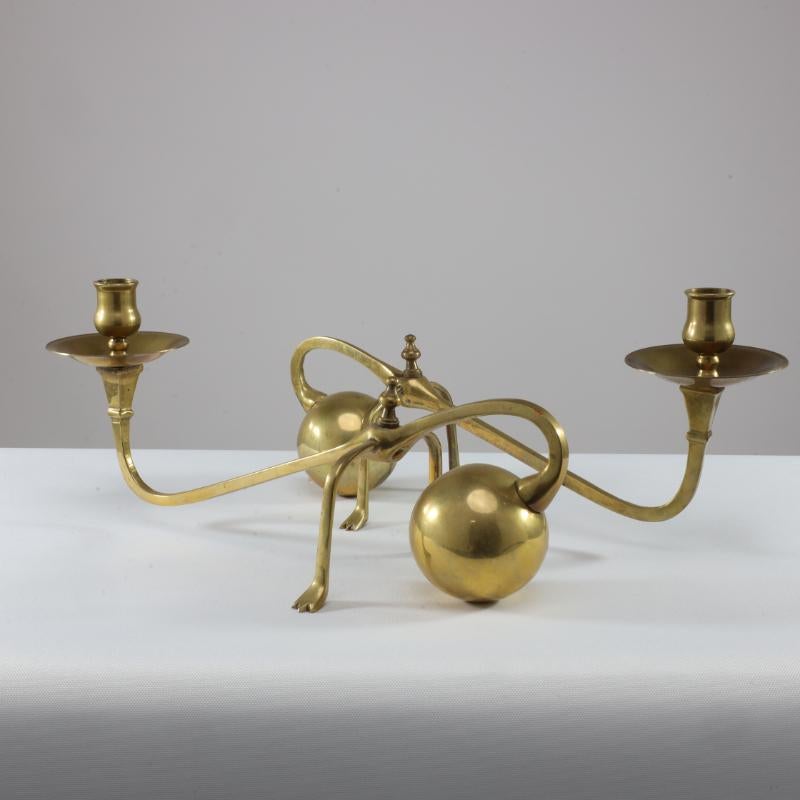 Arts and Crafts WAS Benson (style of). A Pair of Brass Arts & Crafts Piano Candle Holders