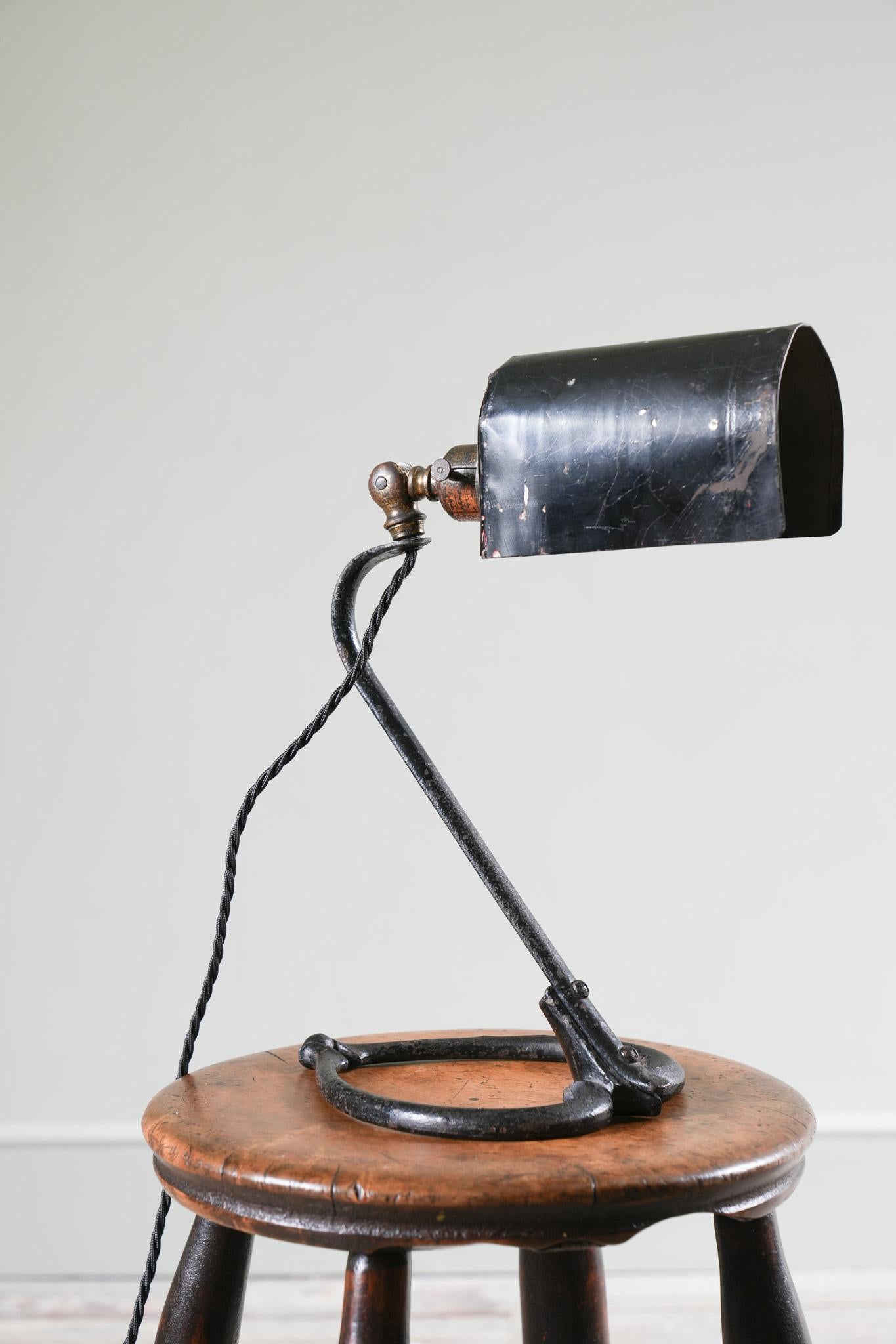 A rare cast and wrought iron table light by WAS Benson with an estate made tin shade.

