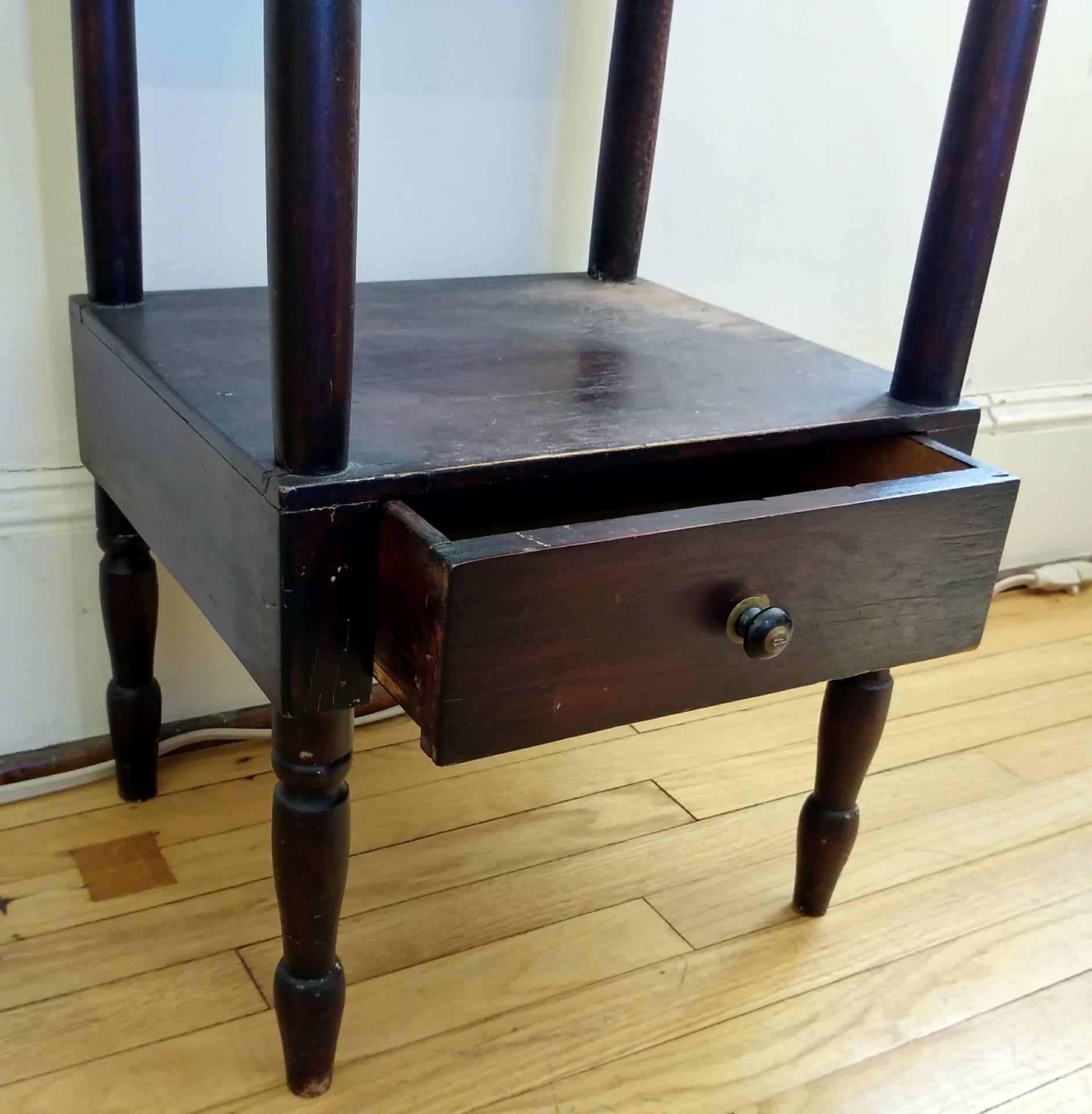Small, dark and handsome! This wooden wash stand from Canada dates from 1880. Notice the sweet drawer on the bottom. We are selling the wash stand as a set with a lovely white ceramic bowl and pitcher. This piece would be wonderful in a bathroom.