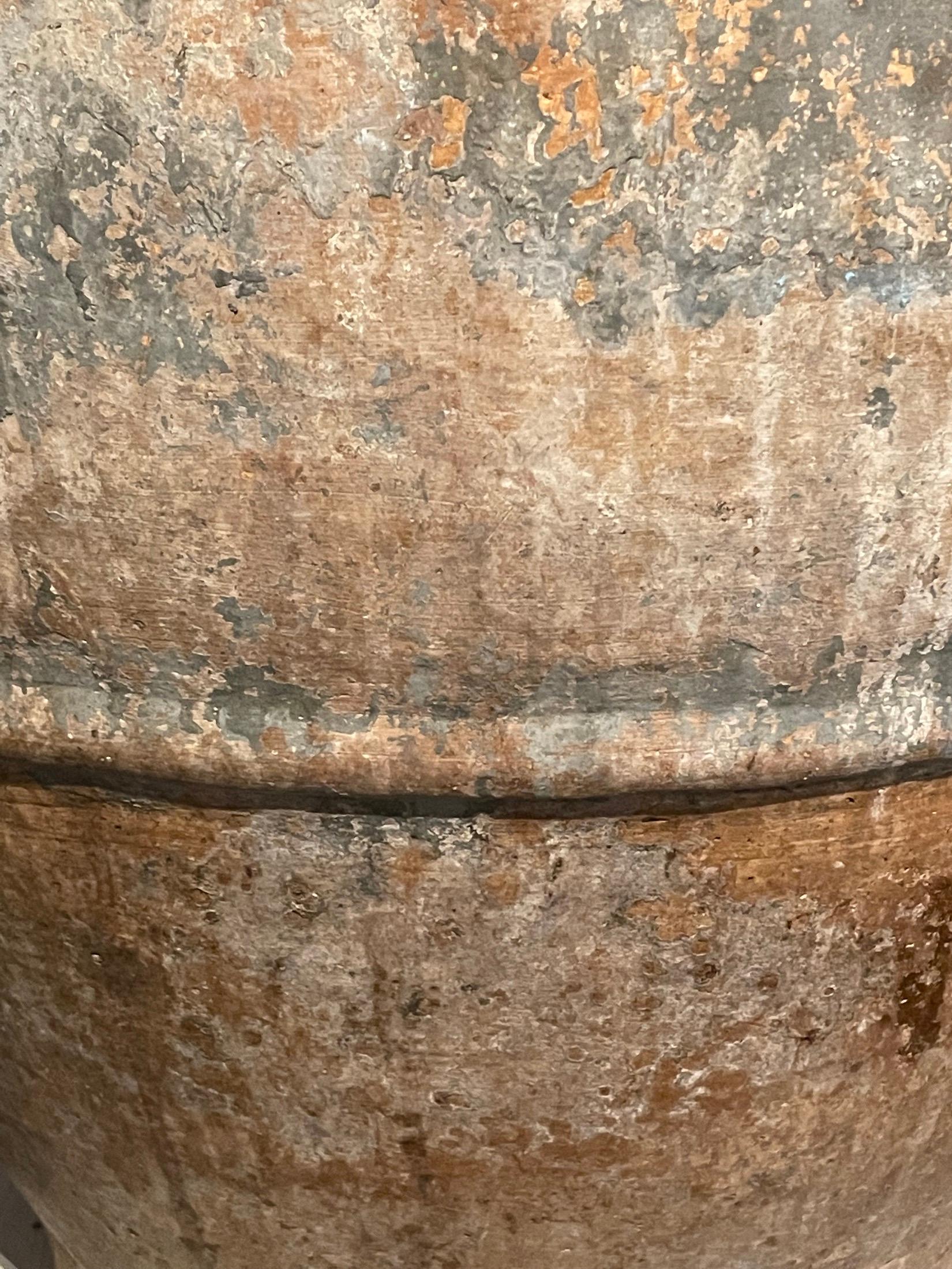 19th century Spanish terracotta olive pot.
Unearthed from a very large family run olive oil producing business in southern Spain.
Beautiful and natural aged patina.
Washed grey and green with single raised texture band.
One of many pieces from a