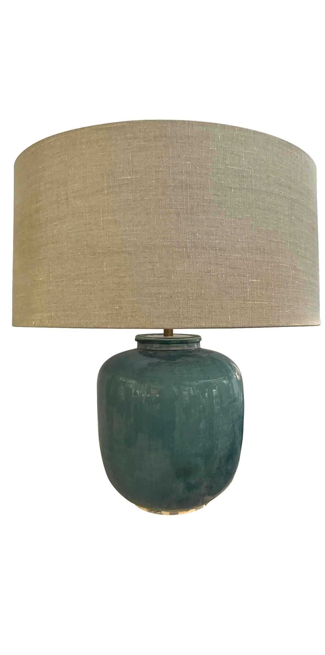 Contemporary Chinese pair of barrel shaped base lamps with a washed turquoise glaze.
New Belgian linen shades diameter 19.5
