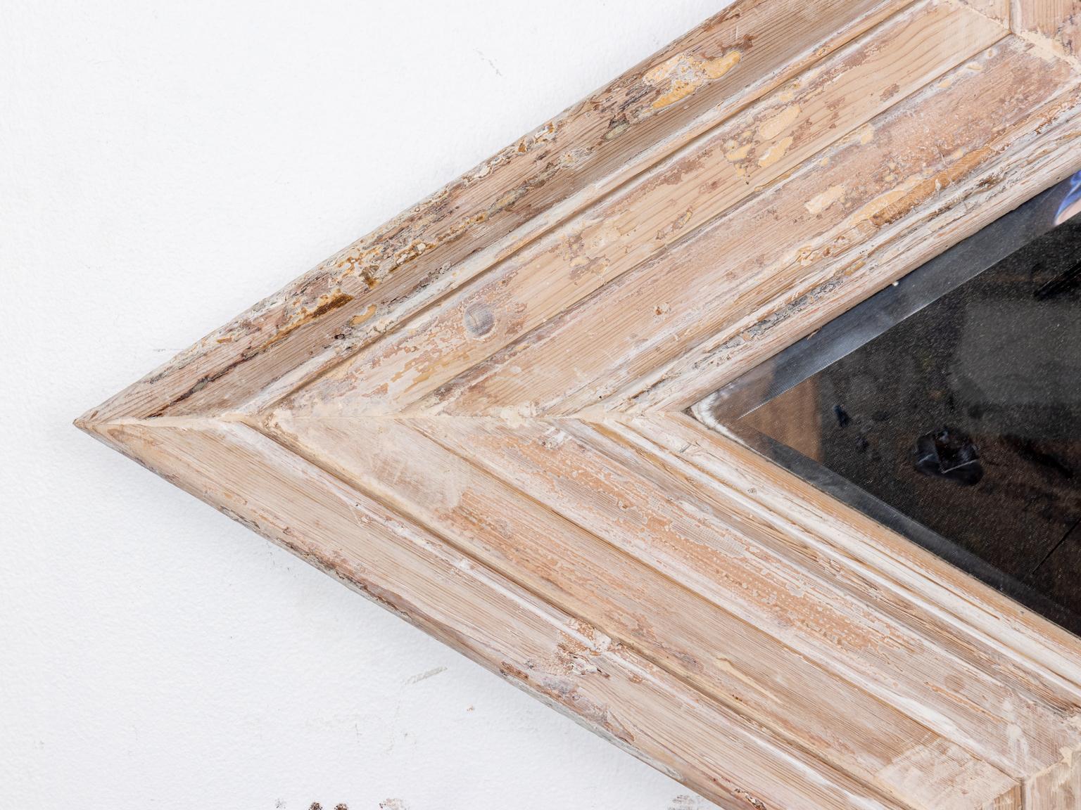 Wood starburst shaped mirror in a whitewashed finish with molded trim and beveled mirror plate. Please note of wear consistent with age including paint loss and distressed finish to the wood.