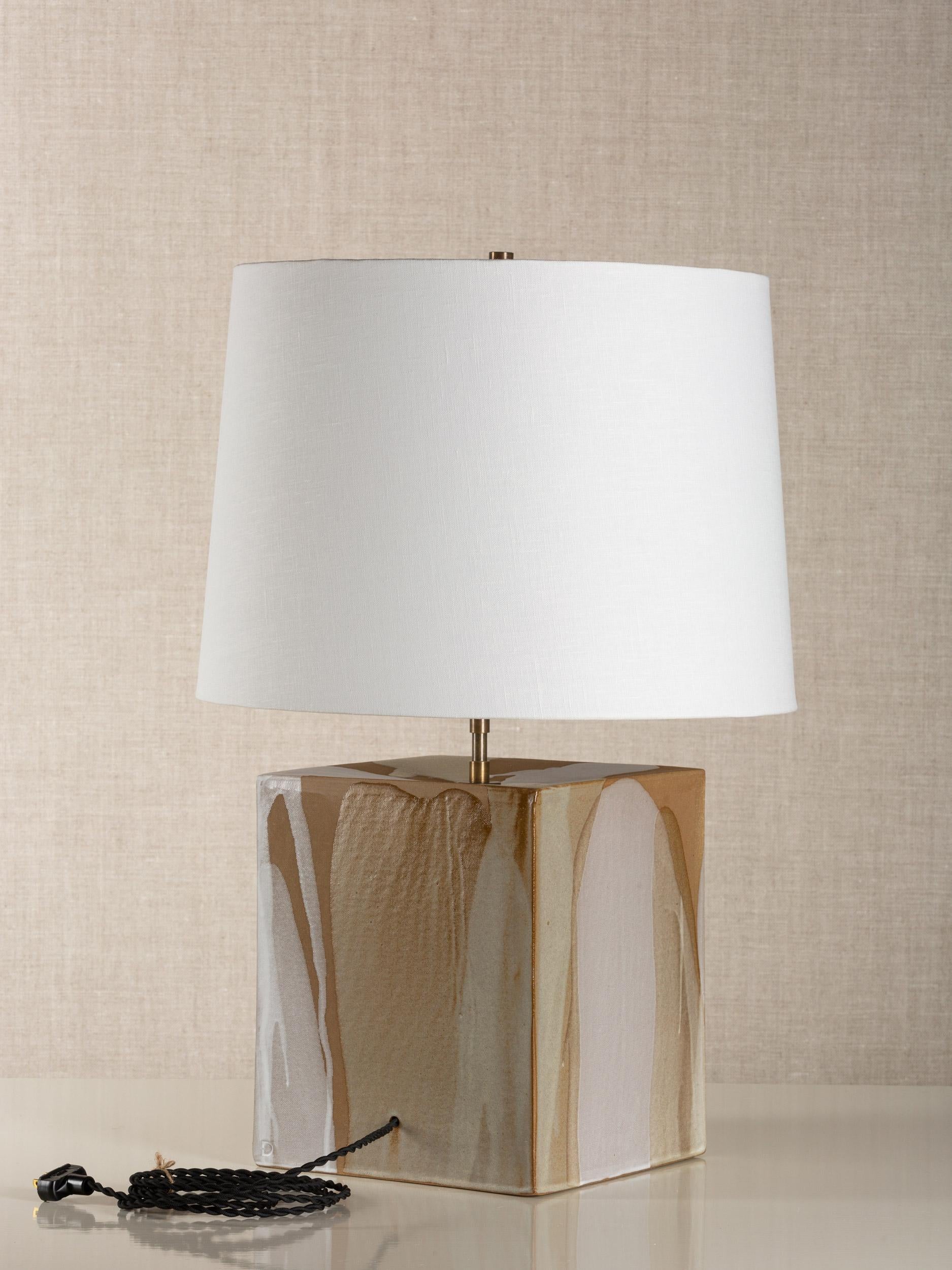 Our stoneware Washington Lamp is handcrafted using slab-construction techniques.

Finish

- Chalk and ochre poured glaze
- Antique brass fittings
- Twisted black-cloth cord
- Full-range dimmer socket
- Off-white linen or paper