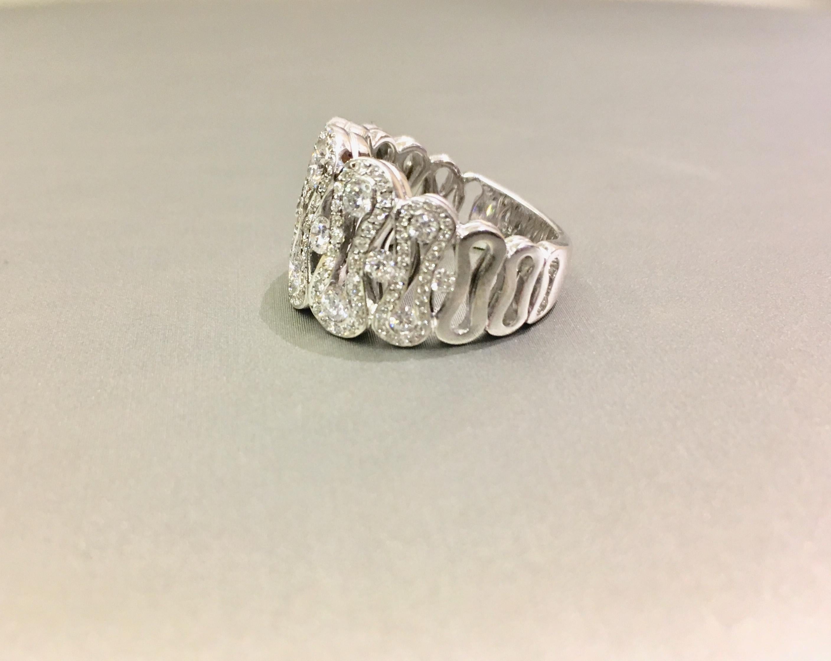 Waskoll diamond pavage 18kt white gold wave ring. The approximate total weight of diamonds are  2.06 tcw,  VS-SI clarity, GH colour. Currently a finger size 7, this band can be re-sized. This diamond band as can be seen in photographs extraordinary