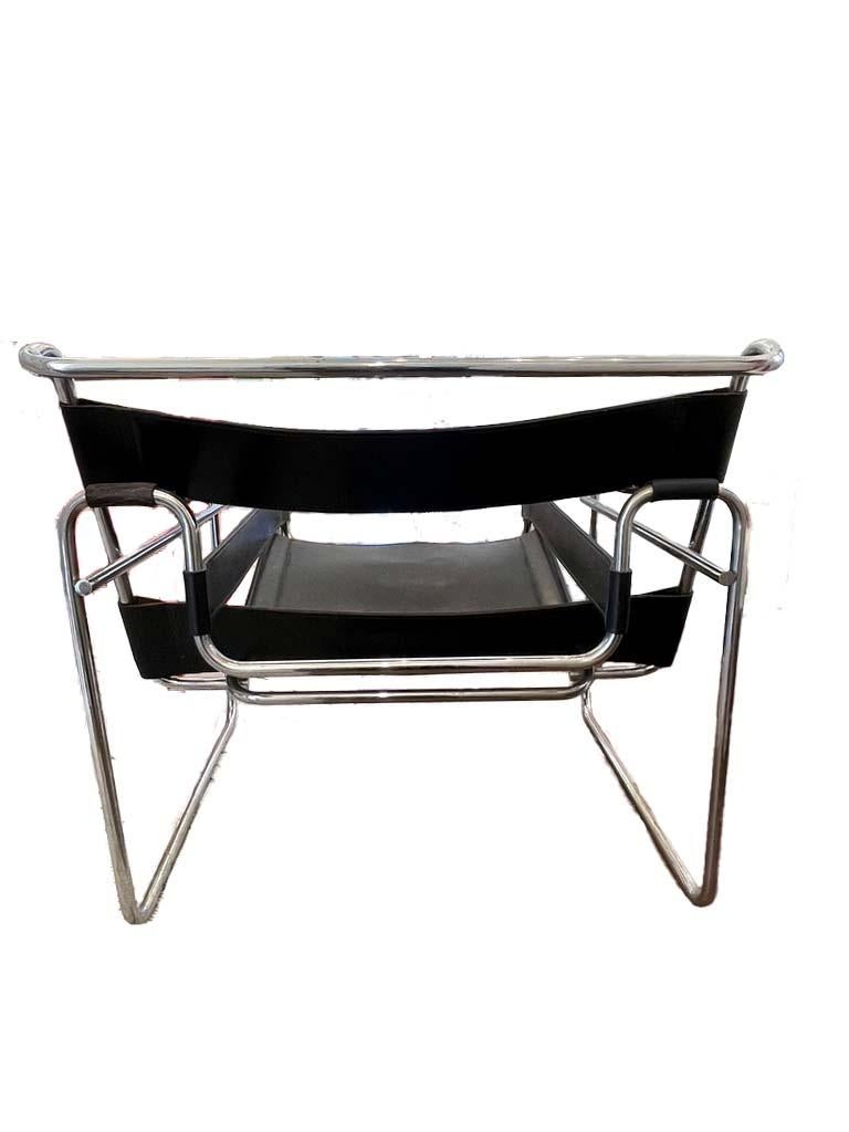 Wassily chair designed by Marcel Breuer dark brown full leather, circa 1960s. This vintage piece has unique traits for authenticity verification such as flat caps on the back seat and thick cowhide leather with cardboard inserts in between each