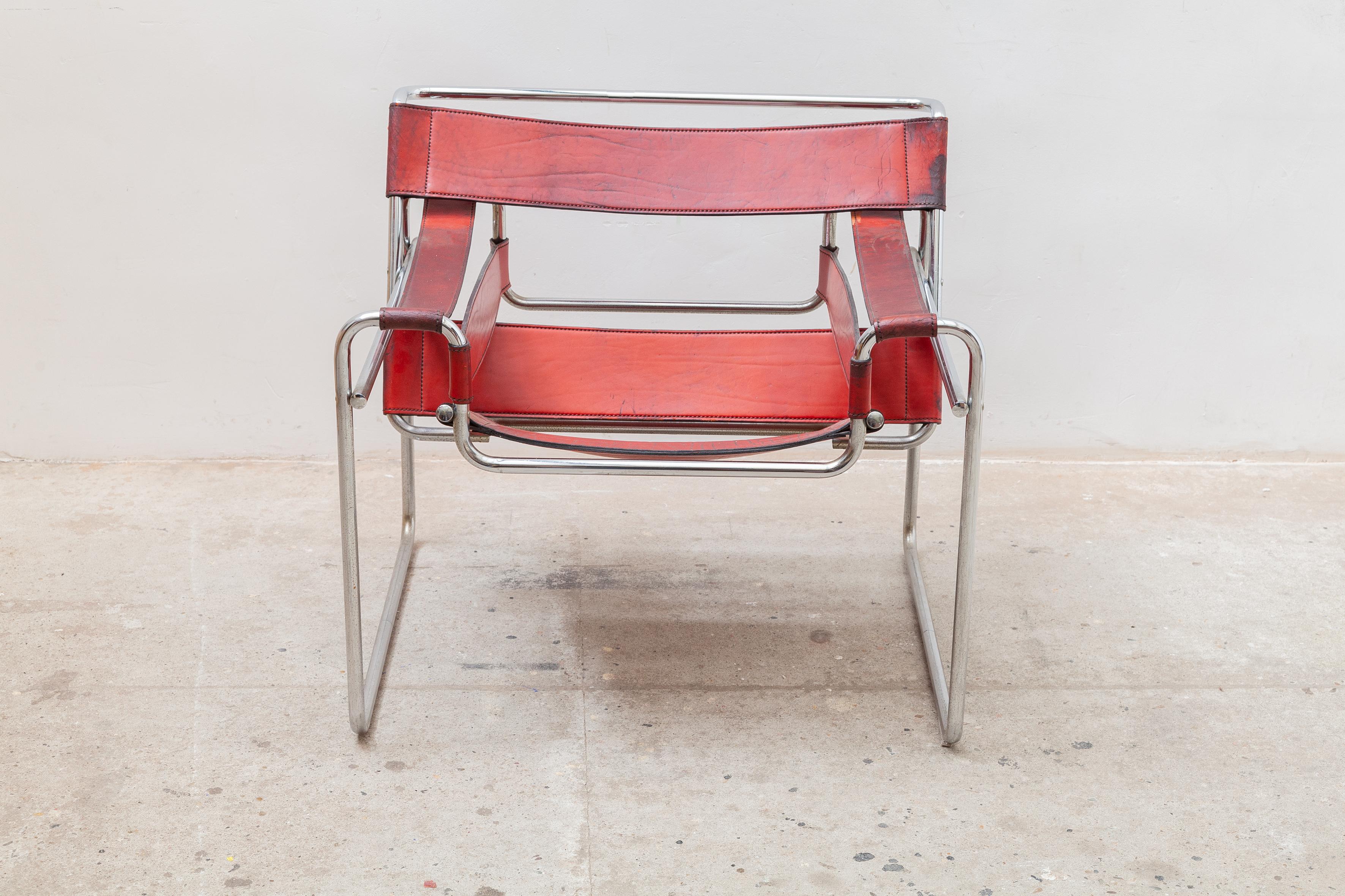 Wassily B3 armchair in red leather, original design from 1925 by Marcel Breuer manufactured in the 1970s. Polished chrome metal tubular frame and original armrests, back and seat. The leather is in good condition with some wear from use with a nice