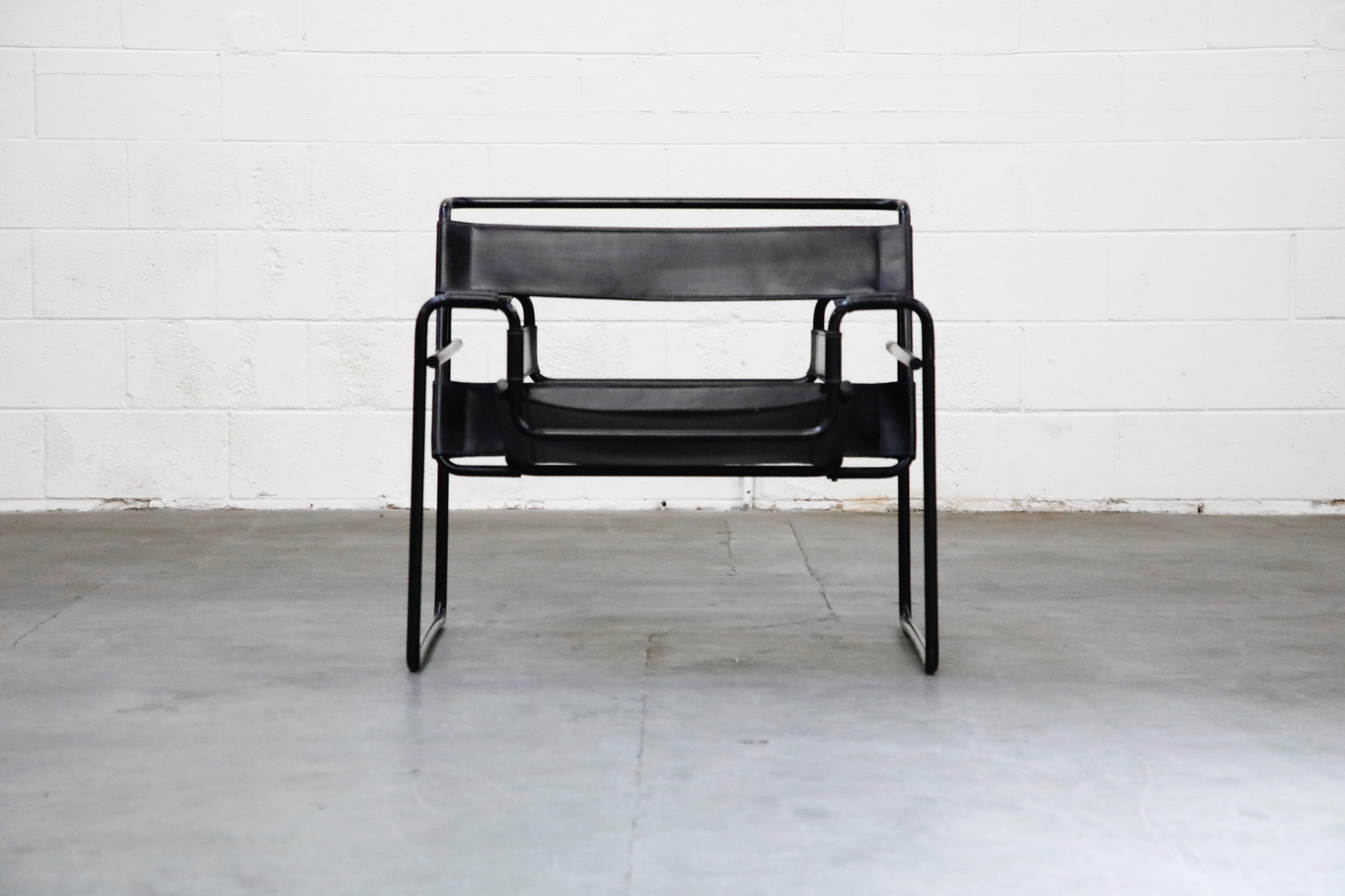 This authentic model B3 'Wassily' lounge chair by Marcel Breuer for Knoll International is a rare black on black colorway featuring a black tubular steel frame and thick black leather slings that make up the seat, arms and seat back. While many