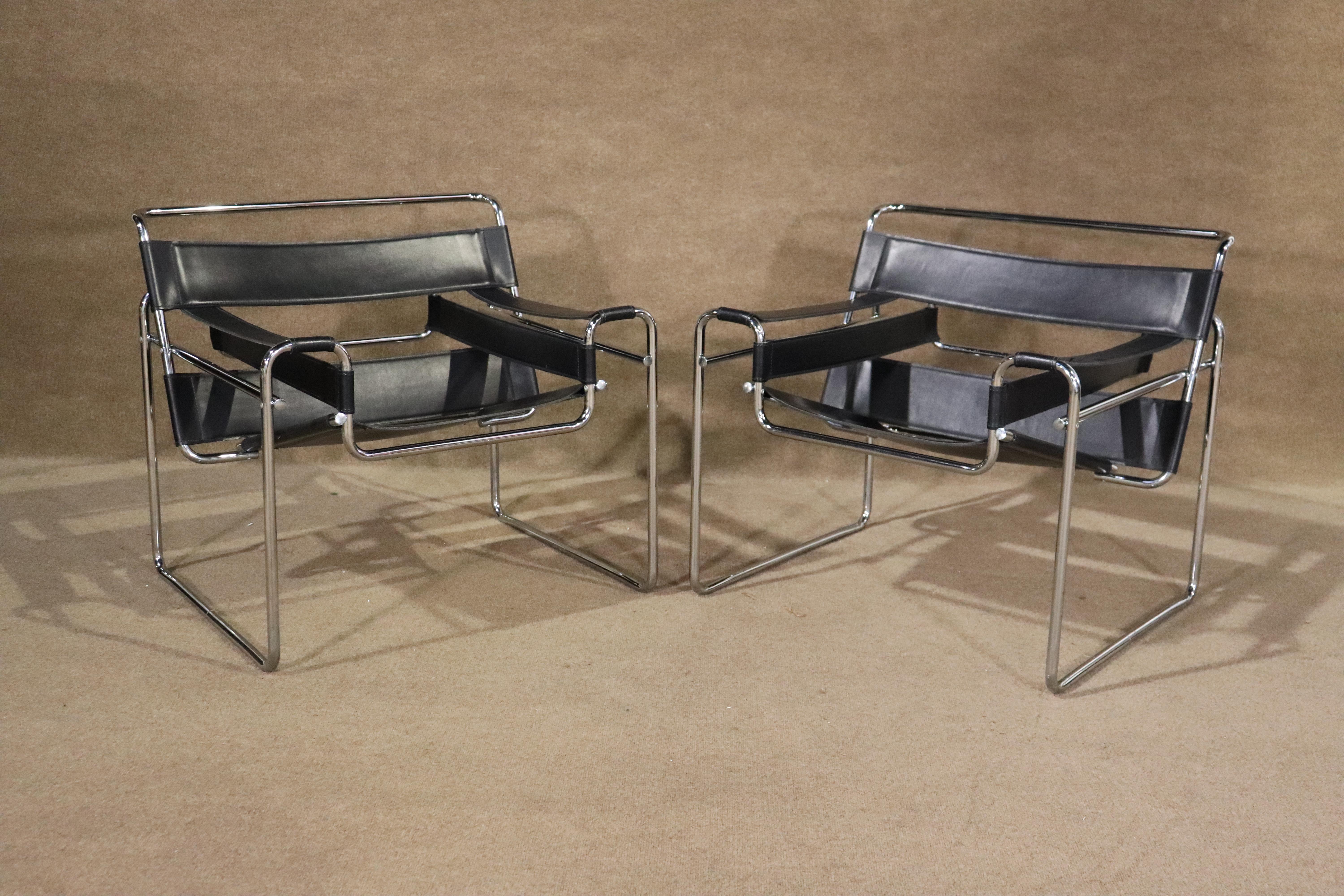 Pair of vintage mid-century modern style armchairs with tubular chrome frames and black straps. In the style of the distinctive 'Wassily' chair made by Marcel Breuer for Knoll.
Please confirm location NY or NJ