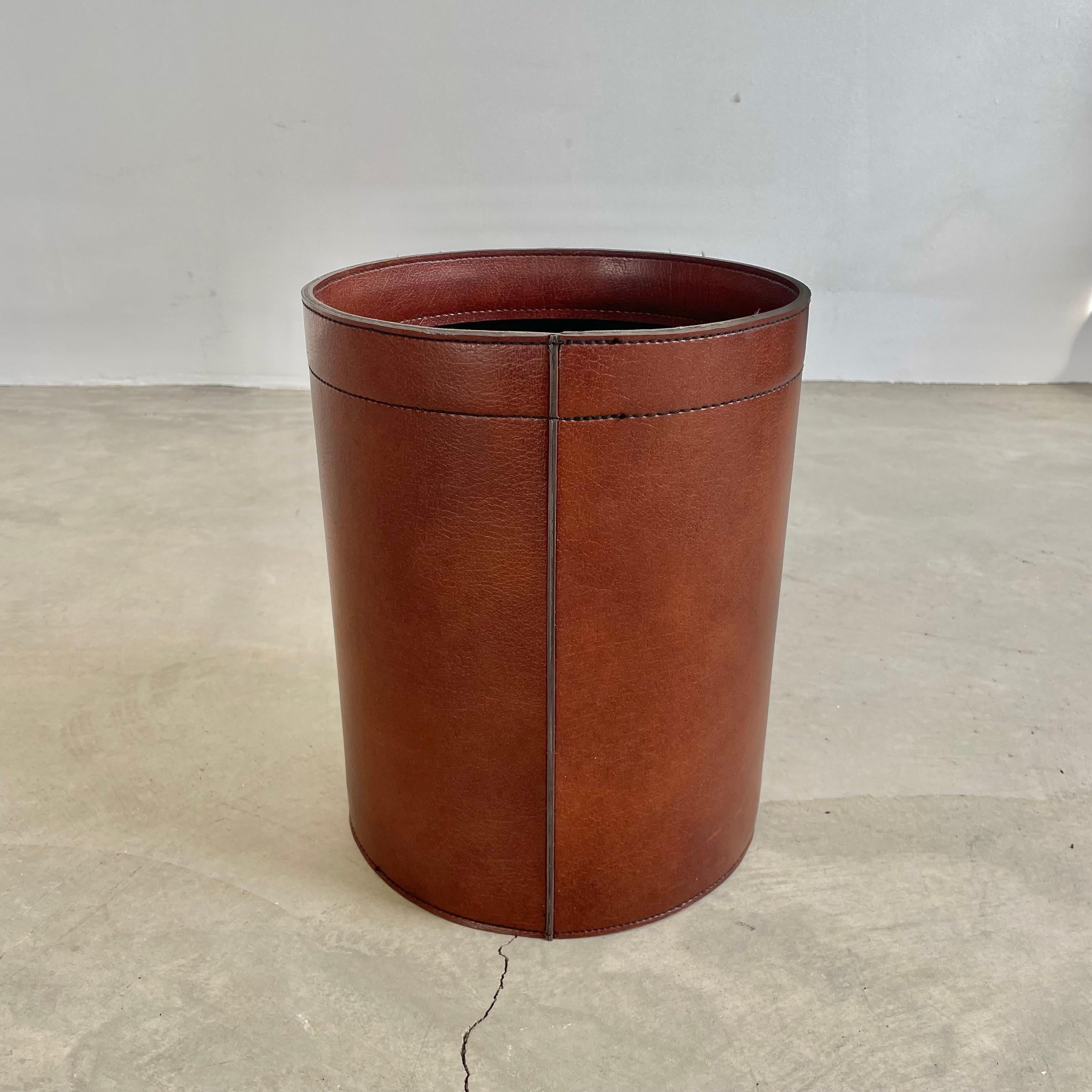 Beautiful waste bin in brown vinyl with a leather texture given to the body. Sturdy cylindrical body with reinforced interior and base. Great color and good vintage condition. 