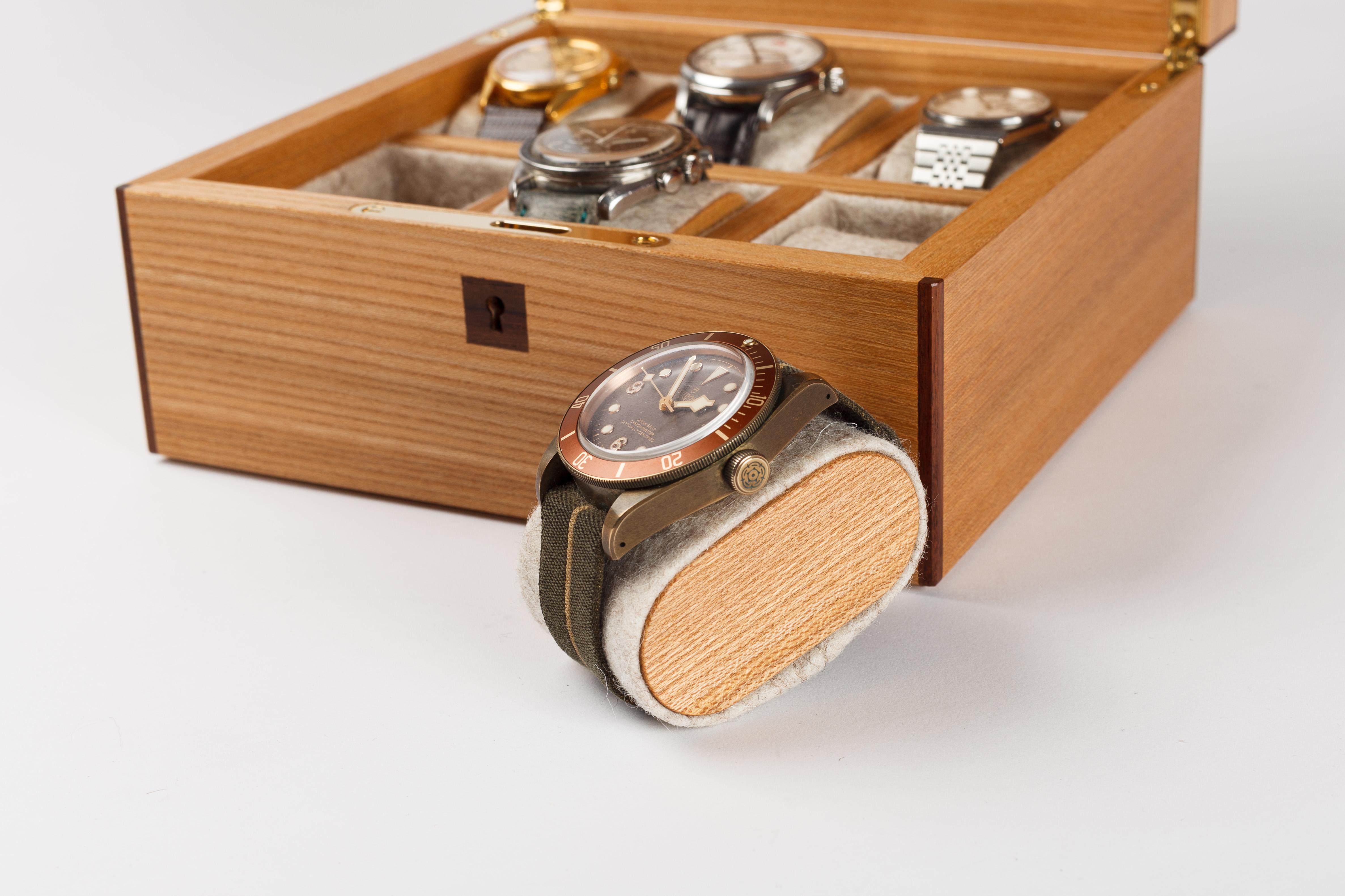 6 Watch box in Scottish elm, with a hand cut parquetry lid in ripple maple and walnut in a basket weave pattern inspired by guilloche watch dials. The box is finished with solid rosewood edge banding and beautifully figured ripple sycamore on the