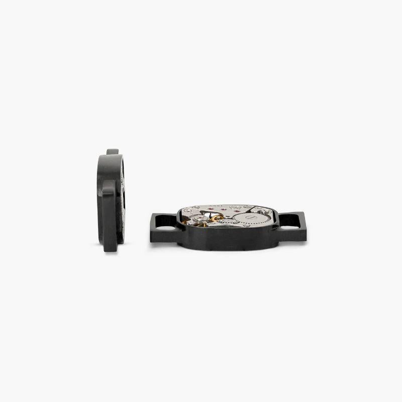 Watch Movement Tonneau shoe links in brushed black IP steel

Inspired by our signature skeleton watch design which will give your shoes a modern, industrial upgrade. Each piece features a hand set vintage watch movement and are sold as a pair to be