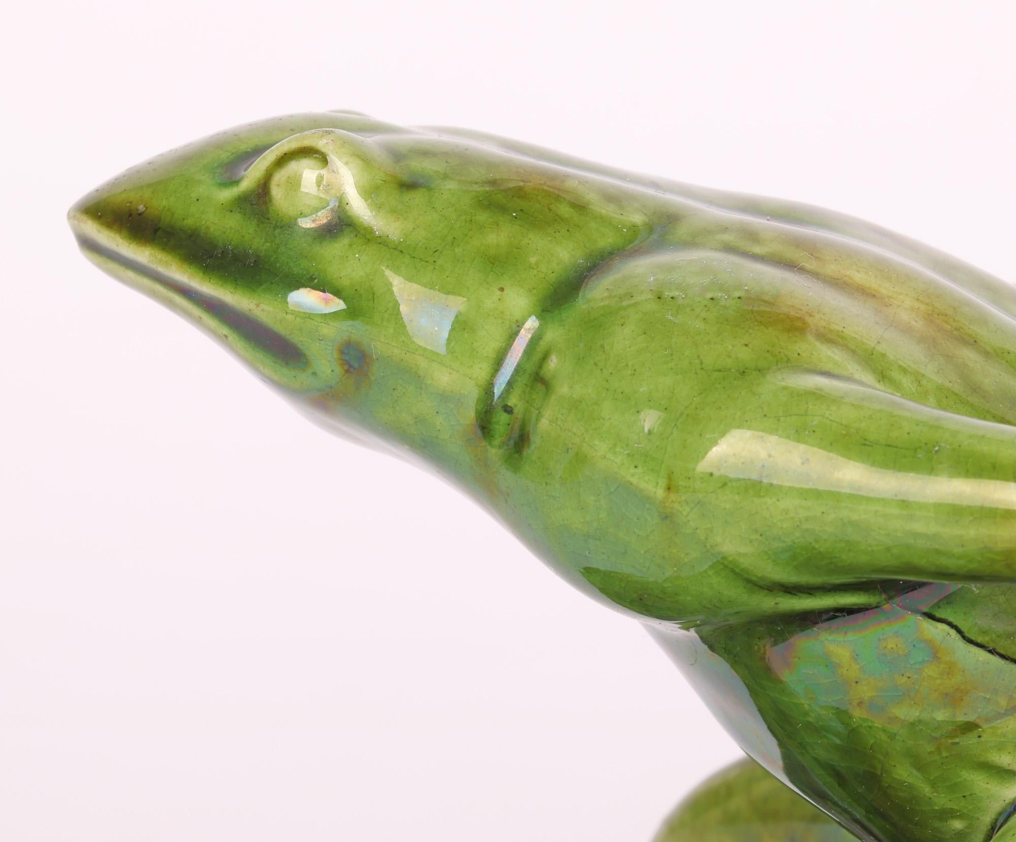 A delightful and scarce Watcombe Torquay Aesthetic Movement art pottery novelty sauce boat modelled as a frog pulling a shell dating between 1880 and 1890. Probably made for Liberty & Co the pottery figure portrays a frog pulling a large shell over