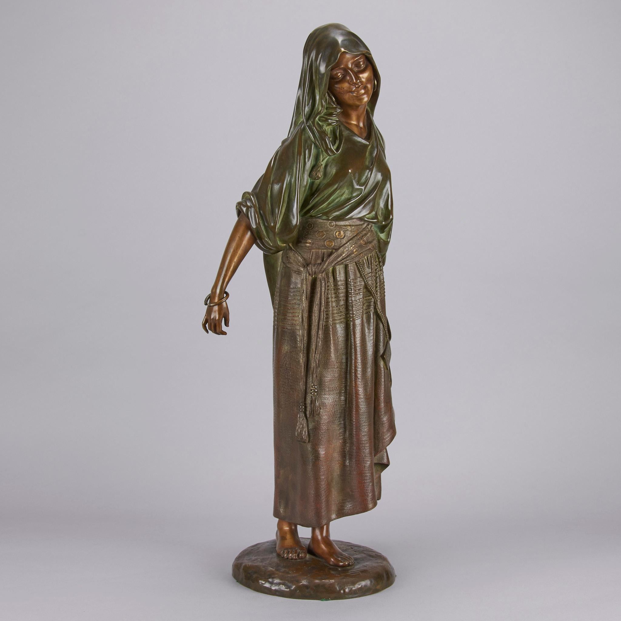 Very attractive early 20th Century Art Deco patinated bronze figure of a young Orientalist woman carrying a ewer of water. The figure with variegated deep green and rich brown and honey undertones, raised on a circular naturalistic base, signed D H