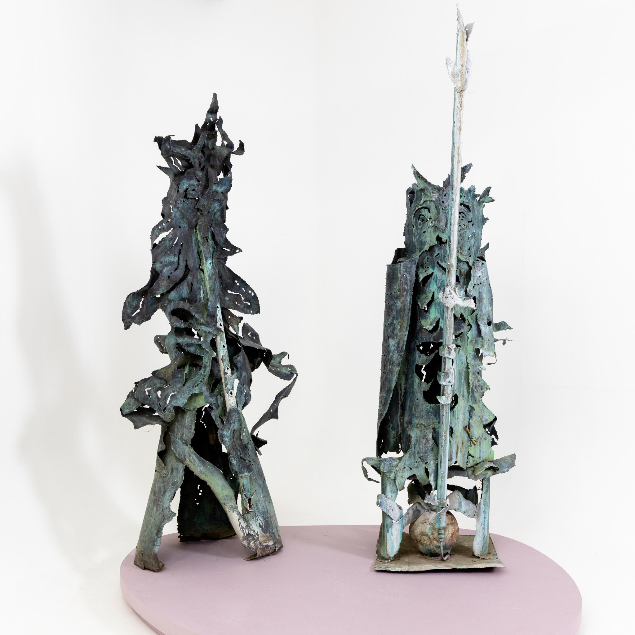 Pair of gargoyles in fanciful design and decorative patina. Dimensions owl: 235 x 75 x 80 cm, flute player: 196.5 x 80 x 73 cm.
