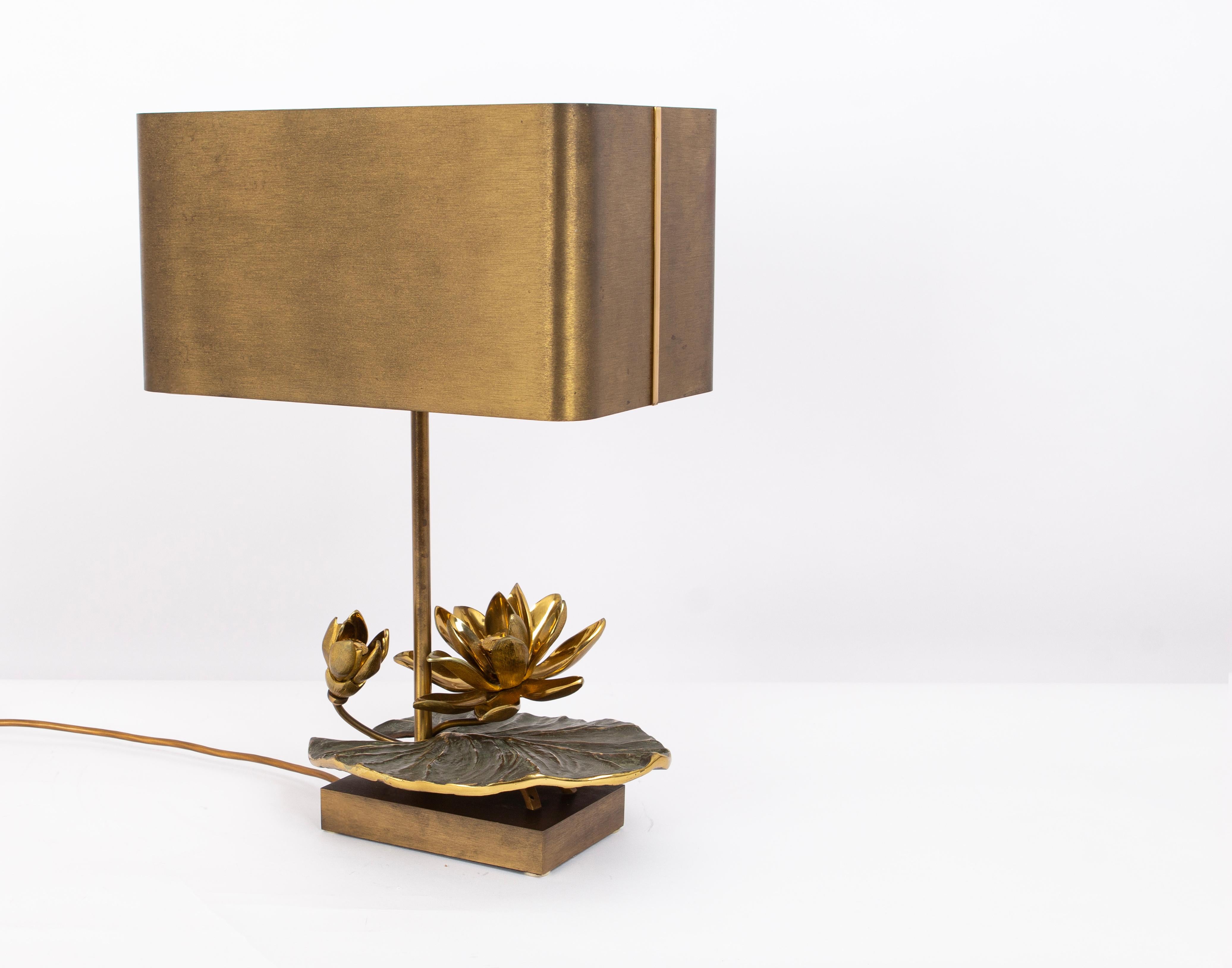 Elegant brass table lamps Model Water Lilly. Designed by Maison Charles, France, 1970s.
The 'Water Lily' model is a celebration of nature's beauty and artistry. The base of the lamp takes its inspiration from the delicate and graceful form of water