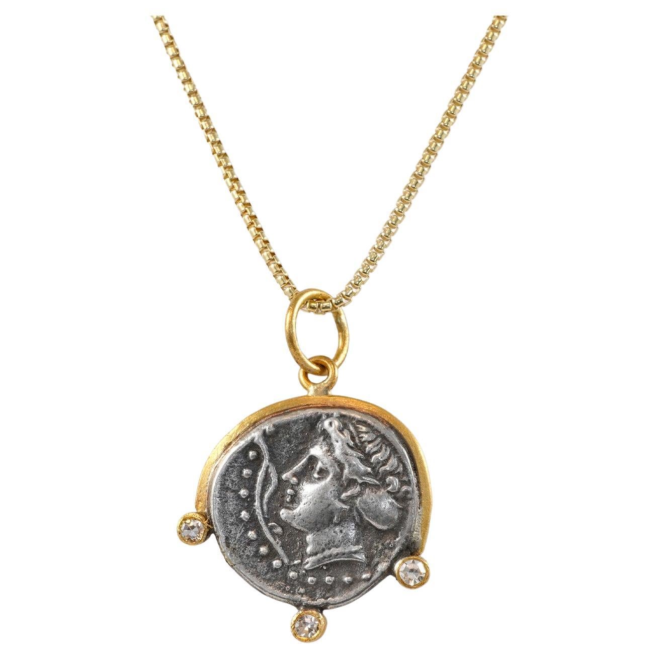 Ancient, Sinope - Water Nymph, Tetradrachm Charm Coin (Replica) Pendant, 24kt Gold, Silver & 0.06ct Diamonds

Sterling Silver coin is a replica coin from those in the Turkish Museum. 360–320 B.C.

3 Diamonds - 0.06cts
24kt Gold 995 - 1.20
