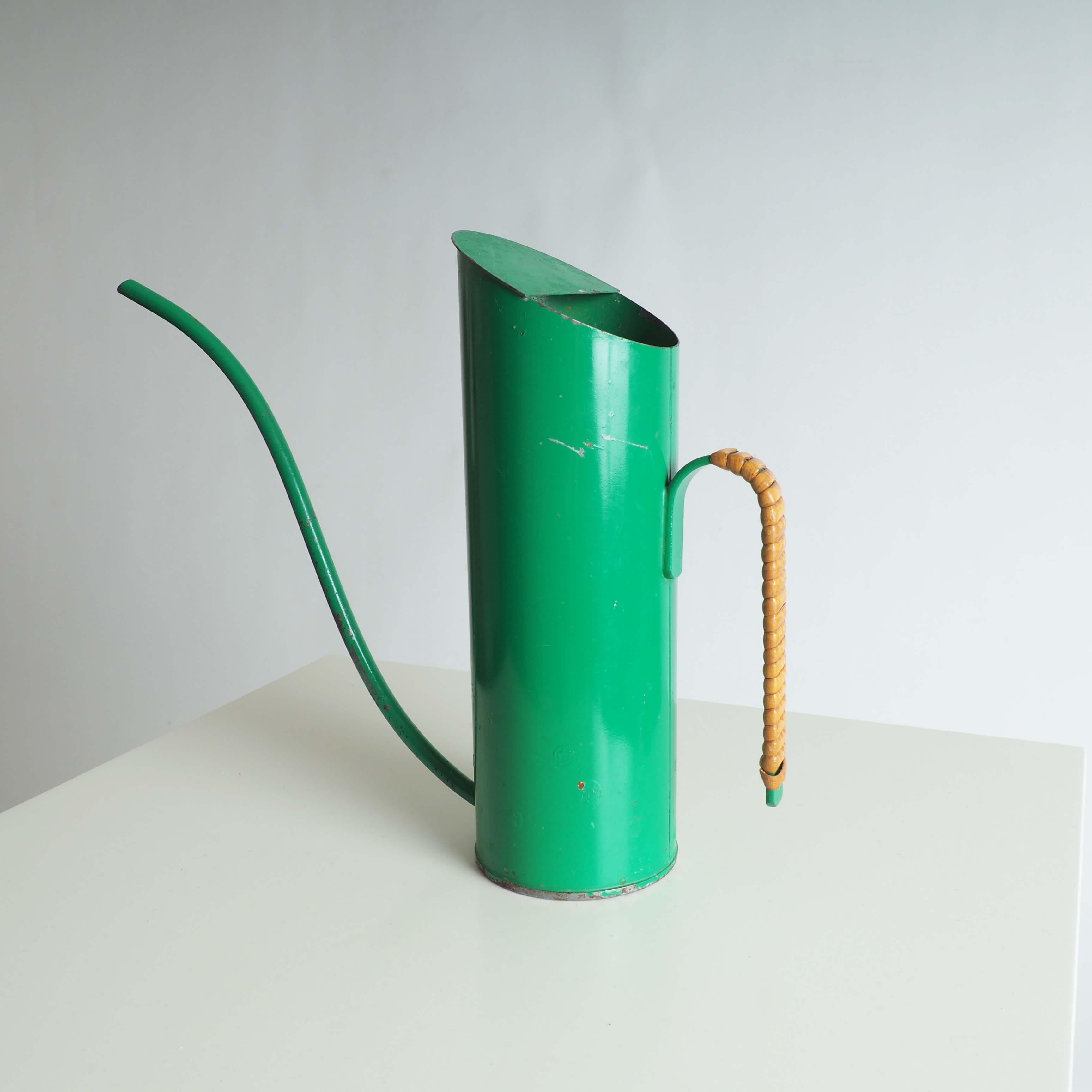 Water pitcher by Gunnar Ander, Ystad Metall, Sweden. Made in painted metal and rattan.

 