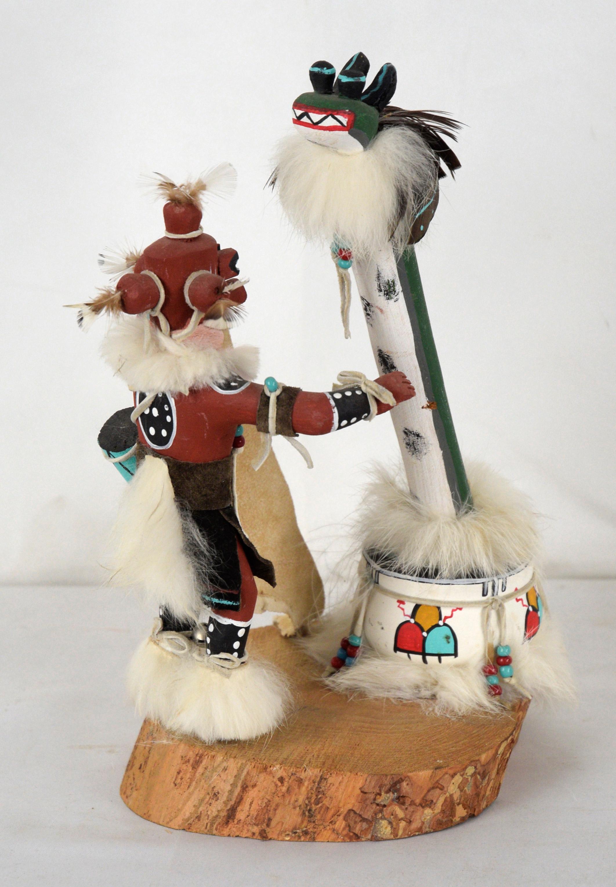 Water Serpent (Palulukang) and Mud Man (Koyemsi) - Kachina Doll

Brightly painted, dynamic sculpture by an unknown artist. The figure is dressed as a medicine man, with feather and fur accents. The Mud Man is holding a piece of leather and a drum,