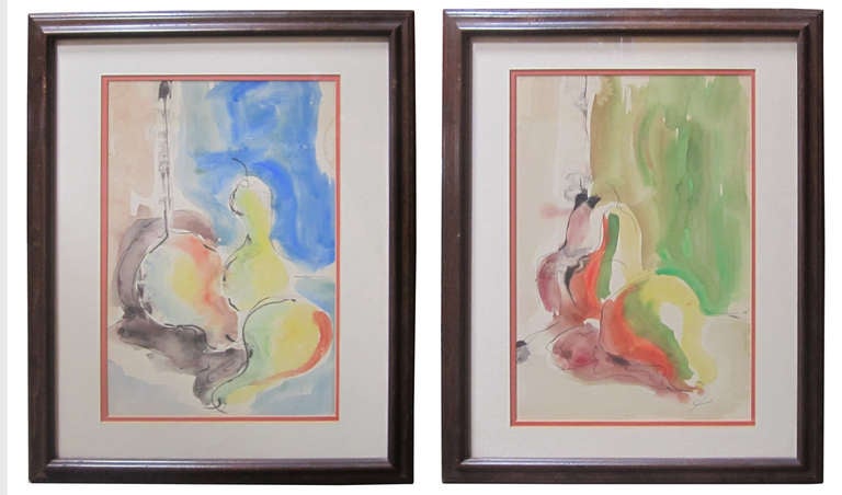 A pair of still life paintings rendered in saturated, fluid watercolor punctuated and outlined by black ink strokes. The pair, which portray pears in different positions, are each framed behind layered cream and orange mats in simple original wooden