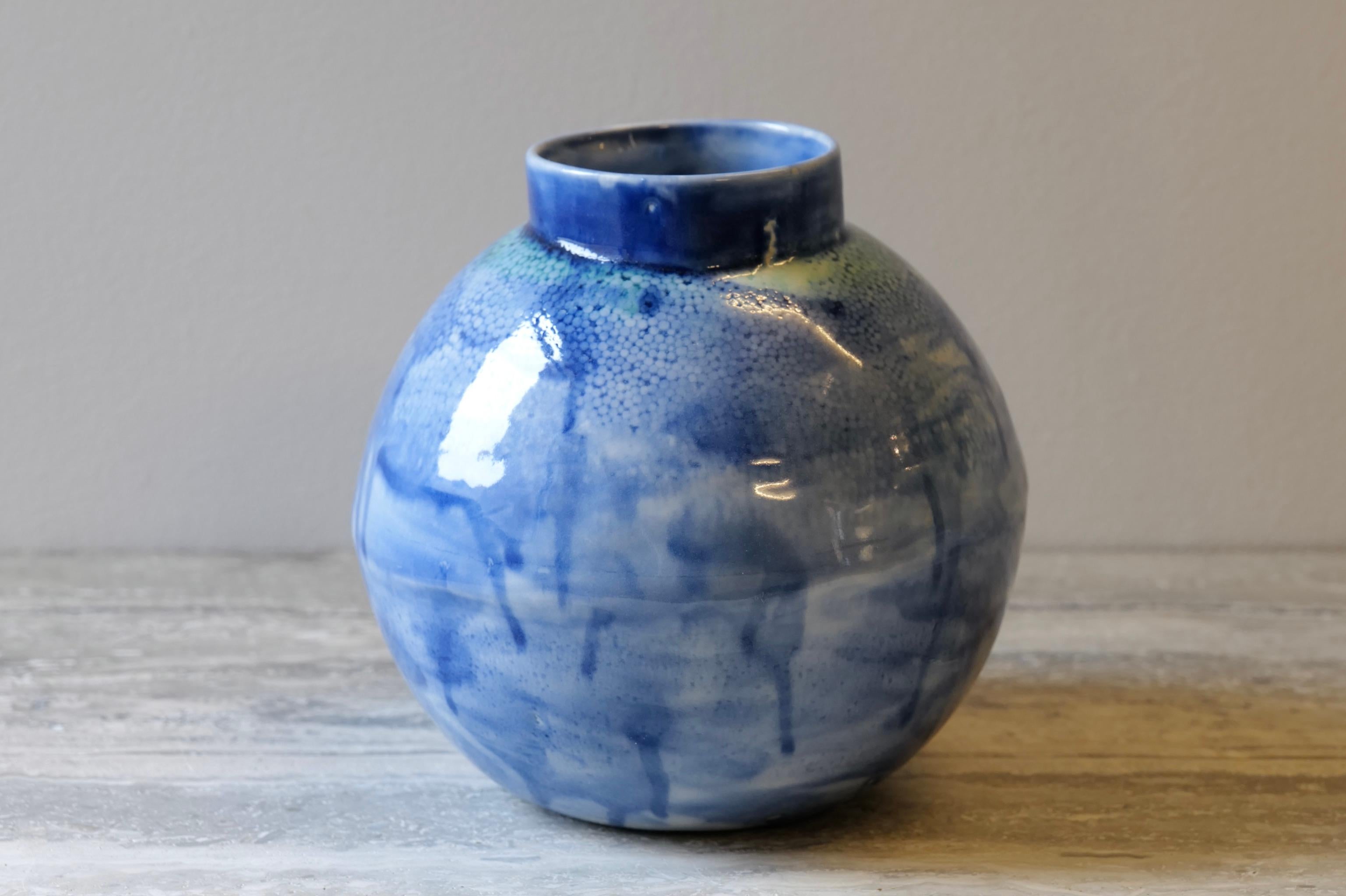 Large spherical orb-like centerpiece. Taking modern inspiration in the form as well as harkening to Japanese tradition in the lip of the vase. The slip-cast porcelain piece has a subtle spherical texture that ranges across the surface. Painted with