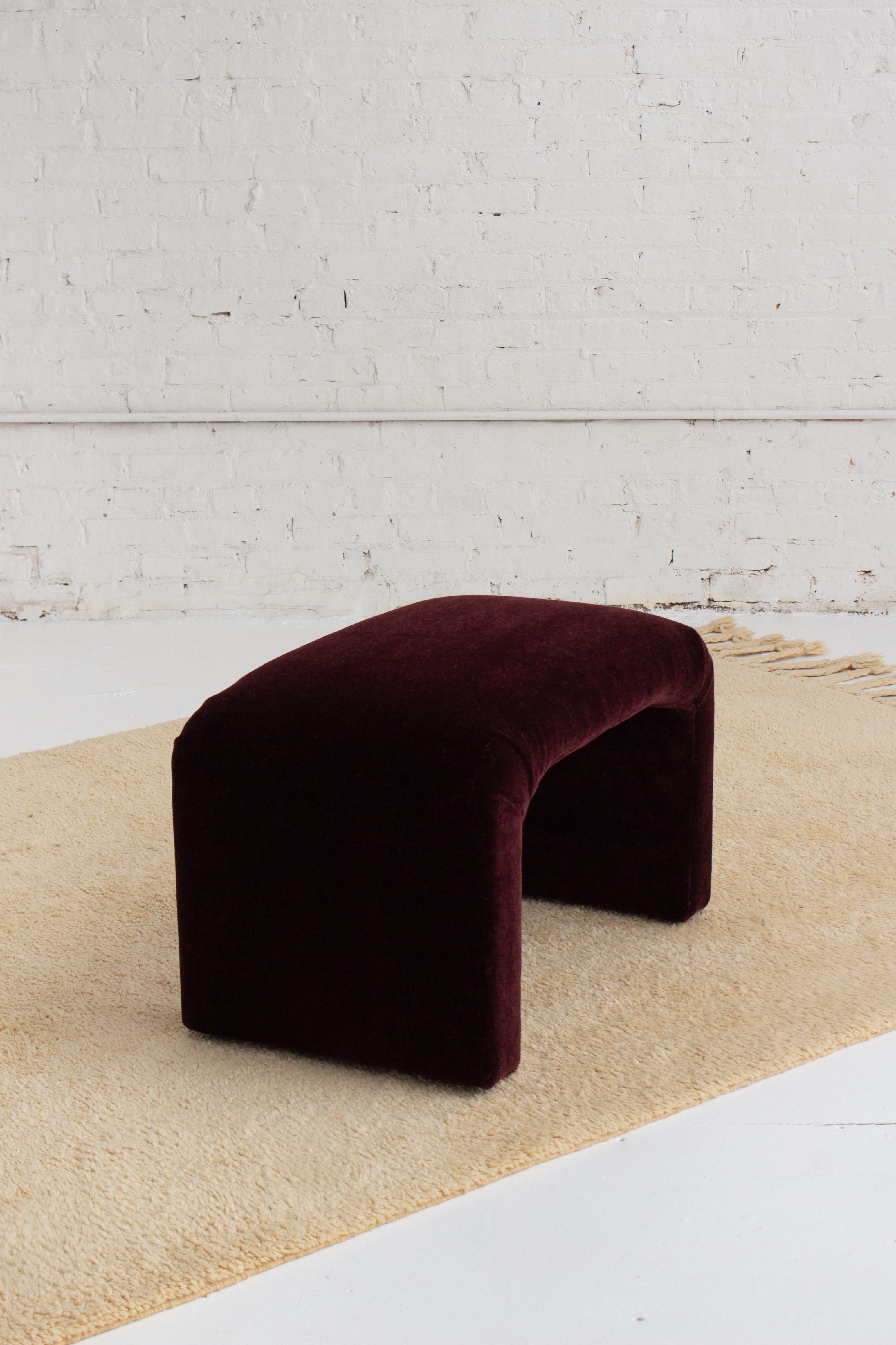 A mid century waterfall bench newly reupholstered in a plush high pile crimson mohair.