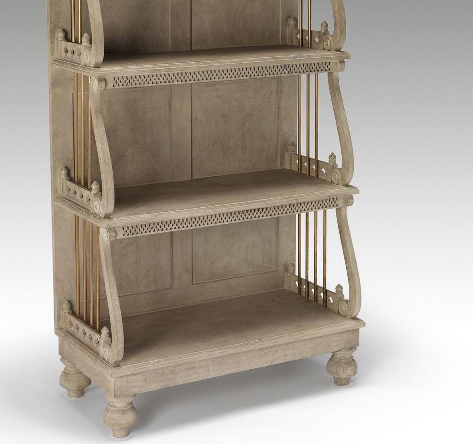 A five-tier waterfall bookcase of tapering form with blind fret and open fret decoration, the ends inset with brass retaining rods. Finished in an aged stone paint with light distressing.

We are currently working to a 30-36 week lead time.