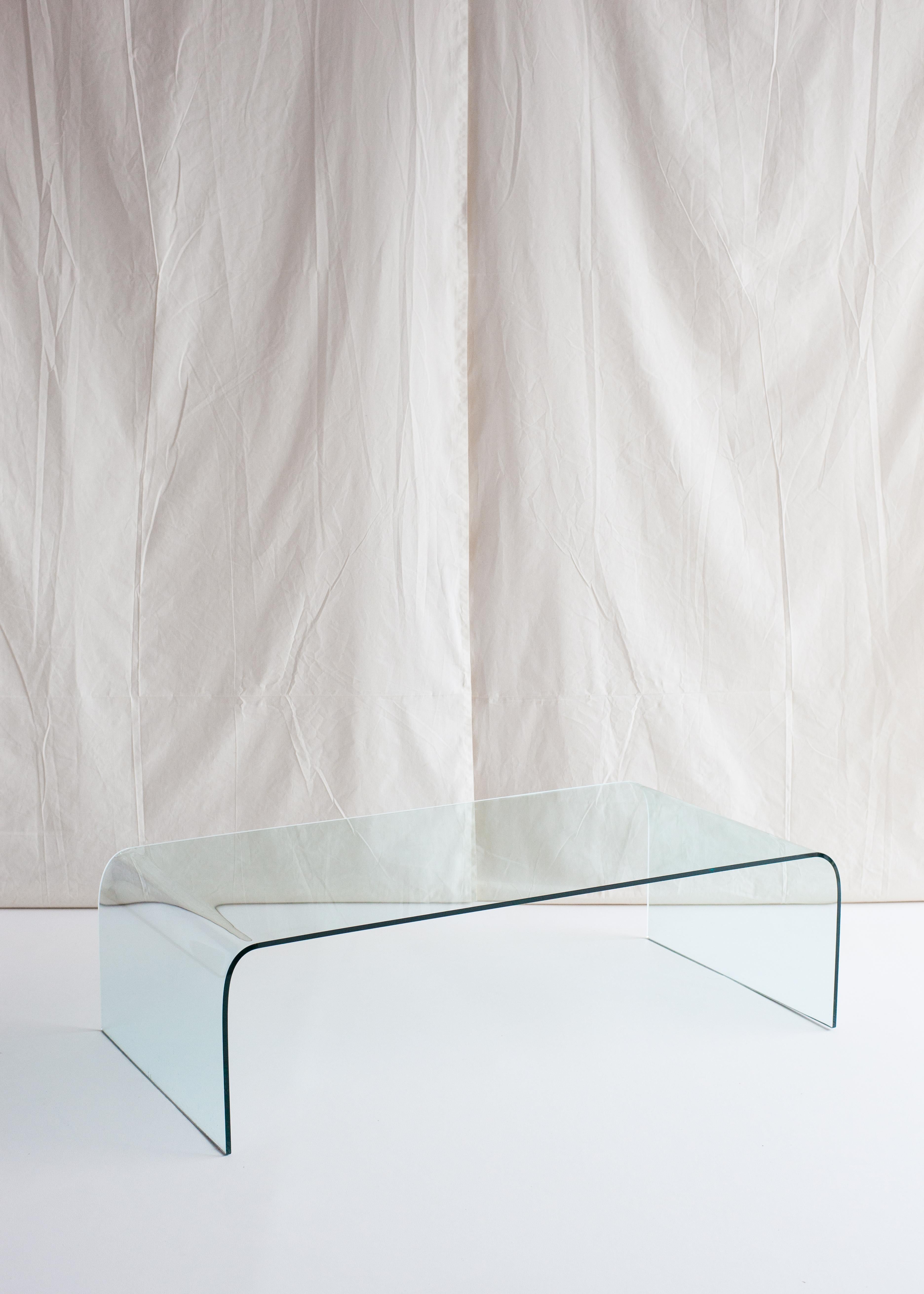 The Waterfall coffee table by Angelo Cortesi for Fiam, 1970s 

Already in 1932 Pietro Chiesa realised the first coffee table in one single piece of curved glass! In the 80s Angelo Cortesi, inspired by his predecessor and using the latest glass