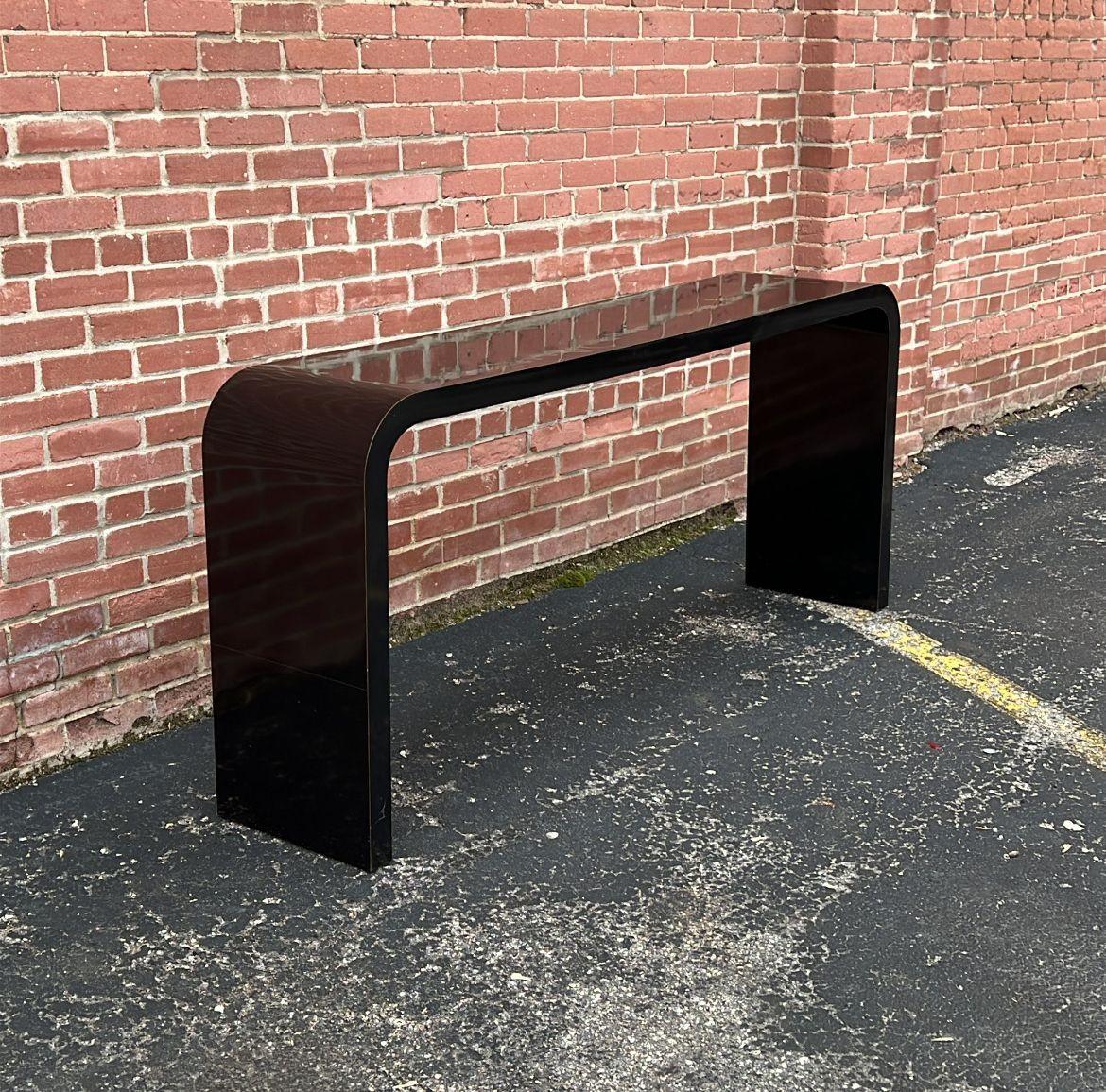 USA, 1970s
Long and taller than most- waterfall console table in durable black laminate. Hearty construction. A very versatile piece- use in a home or in a retail space. Flex to use as a buffet, or for display.
CONDITION NOTES: Fine surface