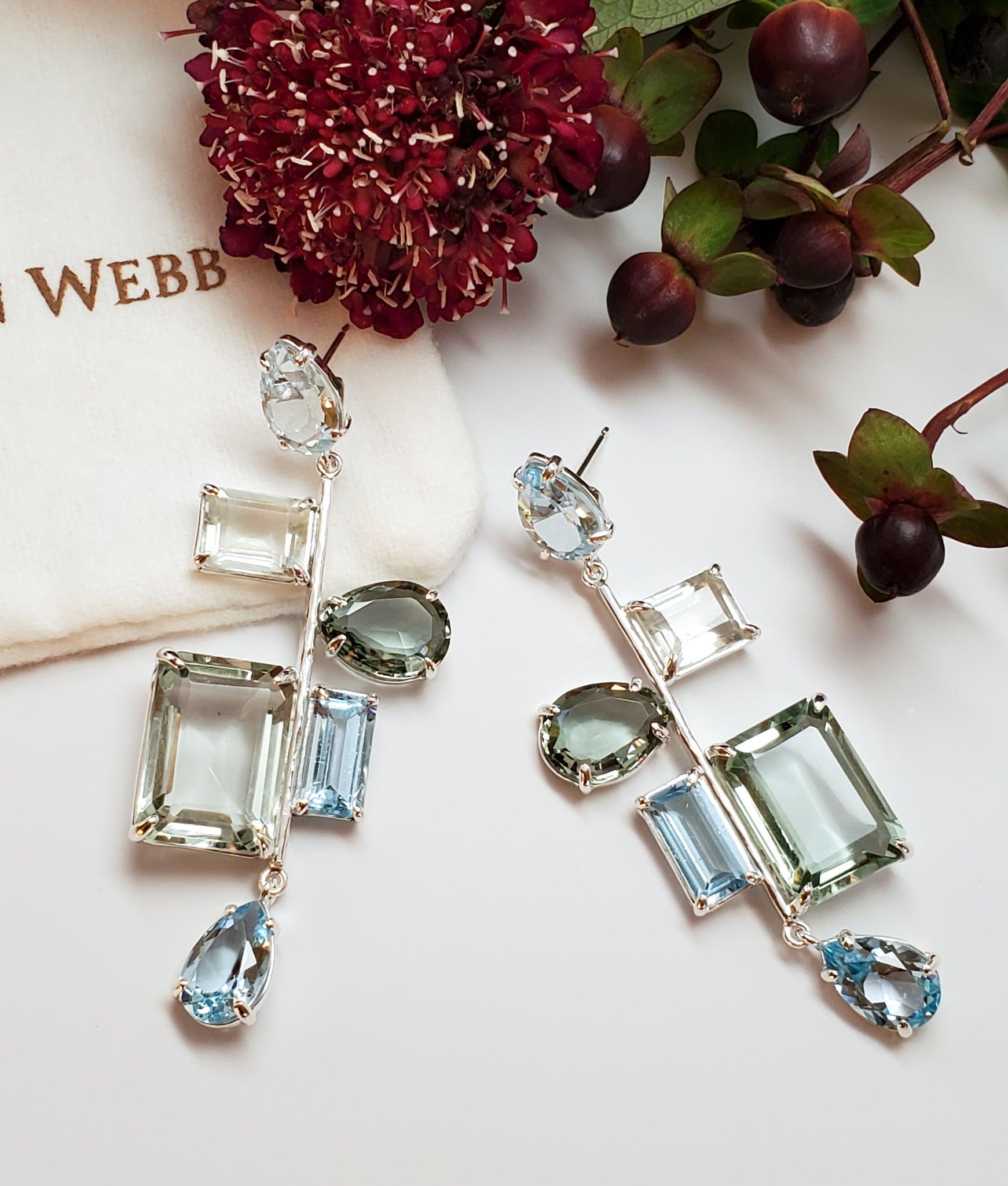 Intention: Let It Flow

Design: Tranquil and refined, yet unexpected and offbeat, these waterfall drop earrings are set in sterling silver with blue topaz, prasiolite, blue quartz and green quartz. Let them guide you downstream, slow down your pace