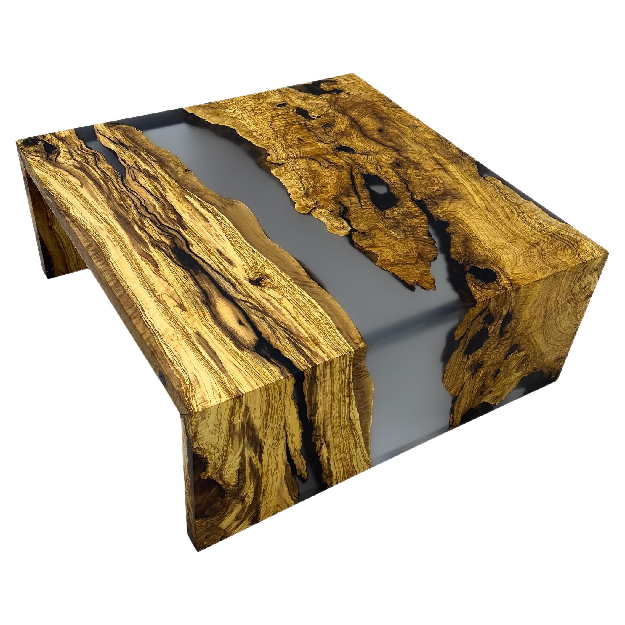 Watefall Epoxy Coffee Table

Handcrafted by skilled artisans, this coffee table seamlessly fuses natural wood with gray epoxy resin, creating a captivating piece that captures nature's beauty. 
Its exceptional design and craftsmanship make it a