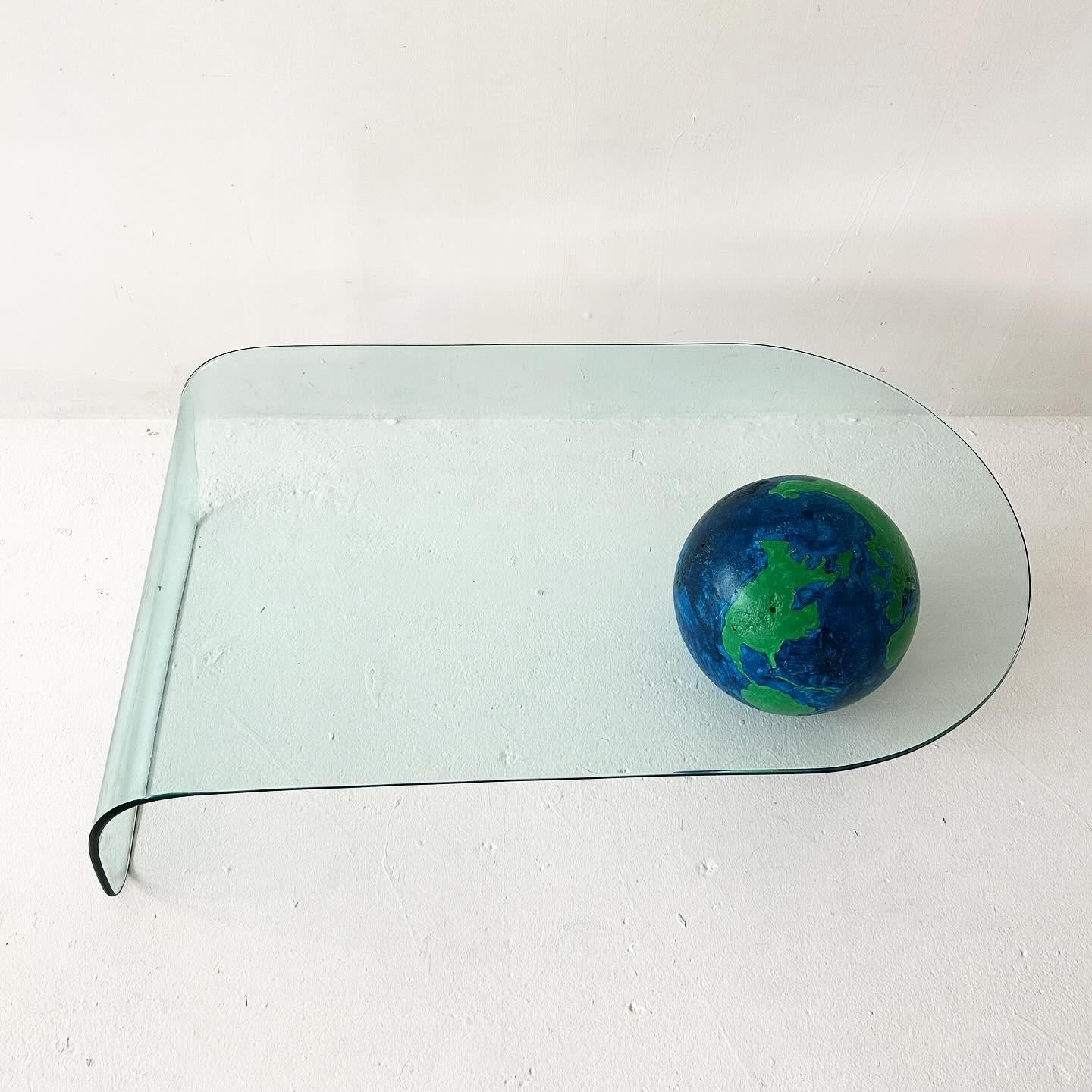 North American waterfall glass coffee table with painted plaster globe For Sale