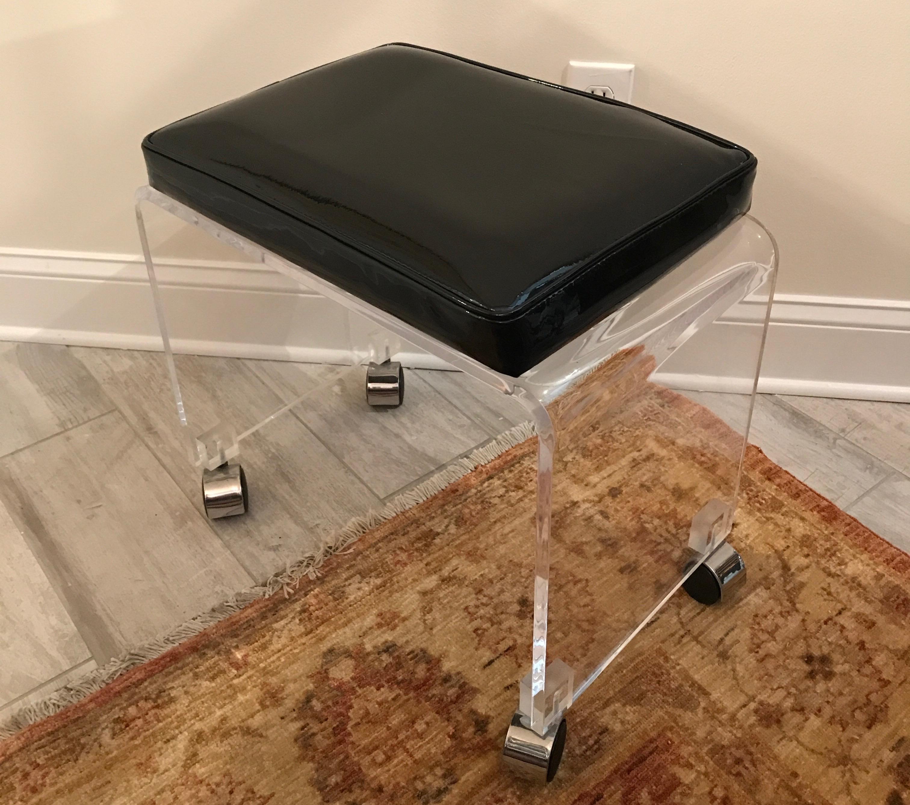 Waterfall Lucite vanity stool with black patent leather seat on casters by Charles Hollis Jones.