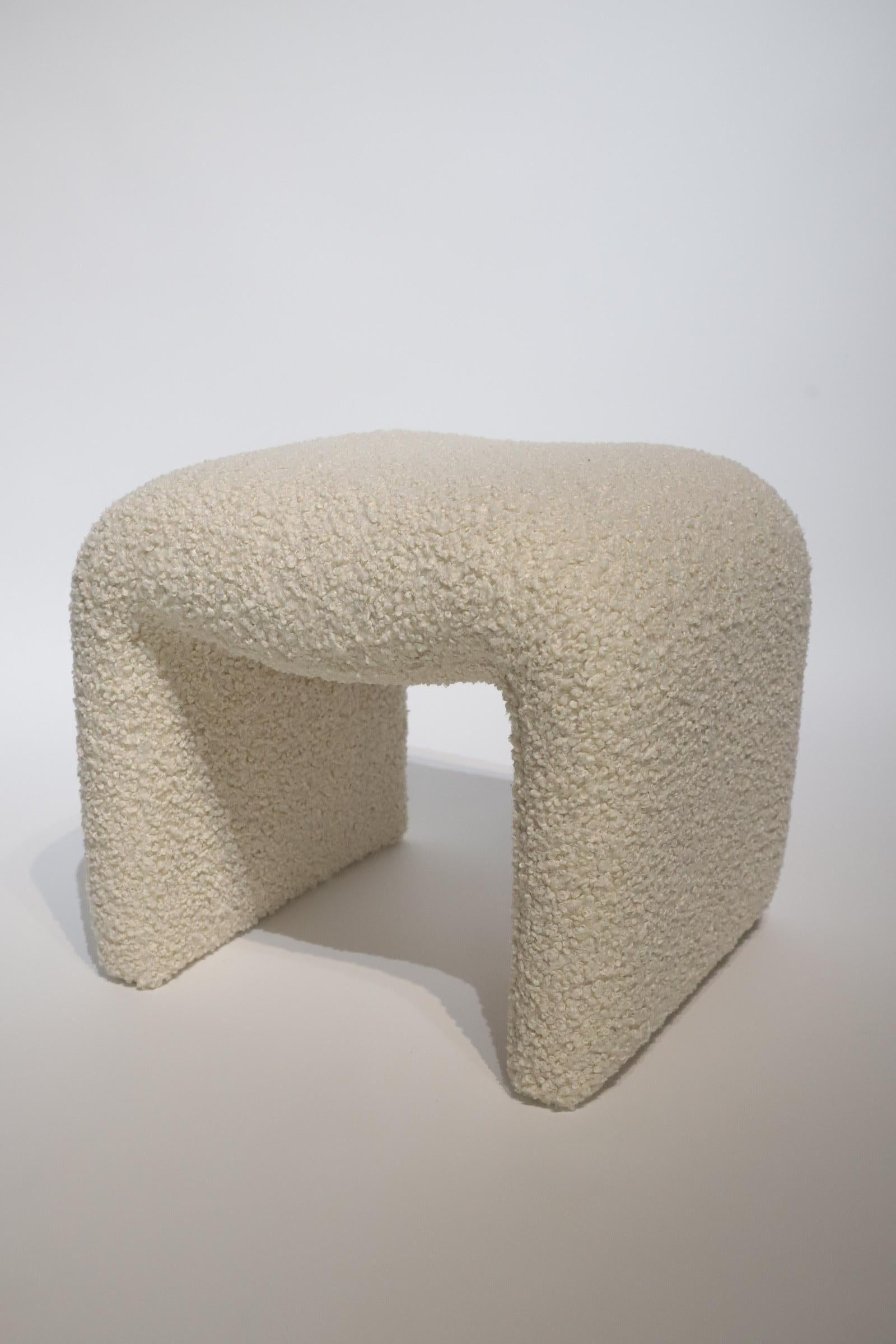 Stunning waterfall stool or ottoman with fresh off-white nubby Alpaca style upholstery. Photographed with Herman Miller Eames DCM for scale. Fabric sample available upon request. Item can be shipped via Fedex. Please contact for quote.