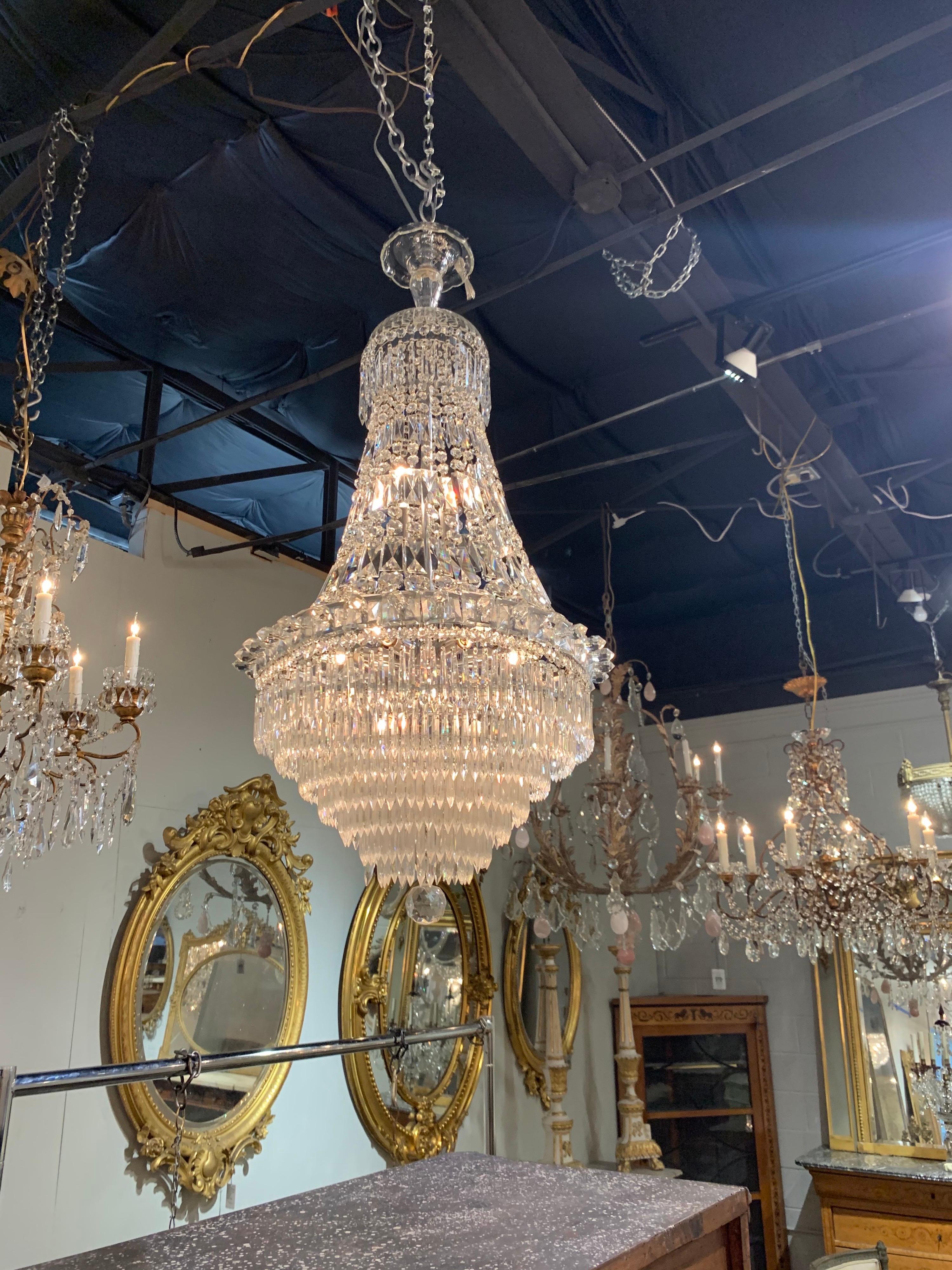 Early 20th century exquisite French waterfall style crystal chandelier. Featuring a lovely array of crystals and prisms. Creates a very classy elegant look!