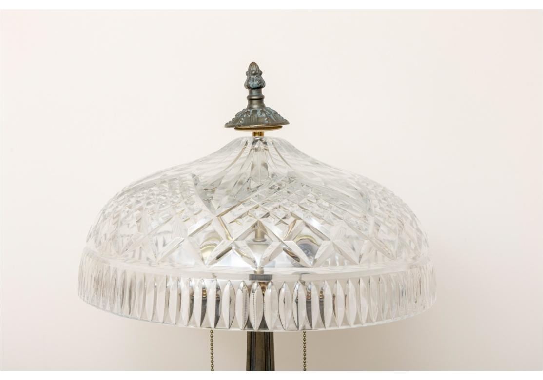 Heavy cut crystal dome form lamp with deep fluted, radiating and diamond cut motifs,. The metal base with a verdigris finish. The lamp with two sockets and pull chain operation.
The lamp is signed on the shade.
Dimensions: 23
