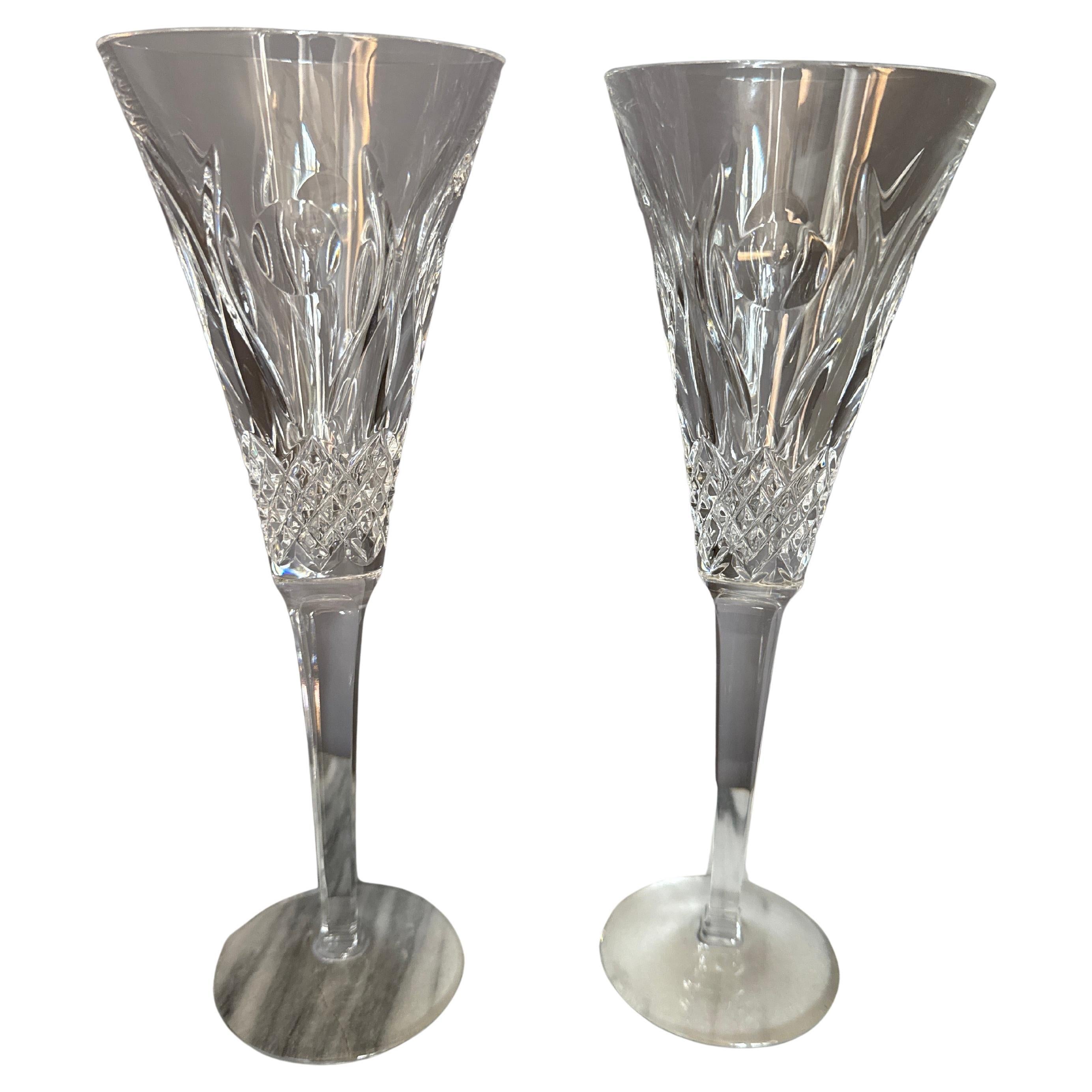 Stunning preowned Waterford Champagne Flute the fourth limited edition the Friendship pattern of Celebration line . The toasting glass has cuts of swirls and dots on the bowl along with small diamond cuts at the base leading to a multisided stem.