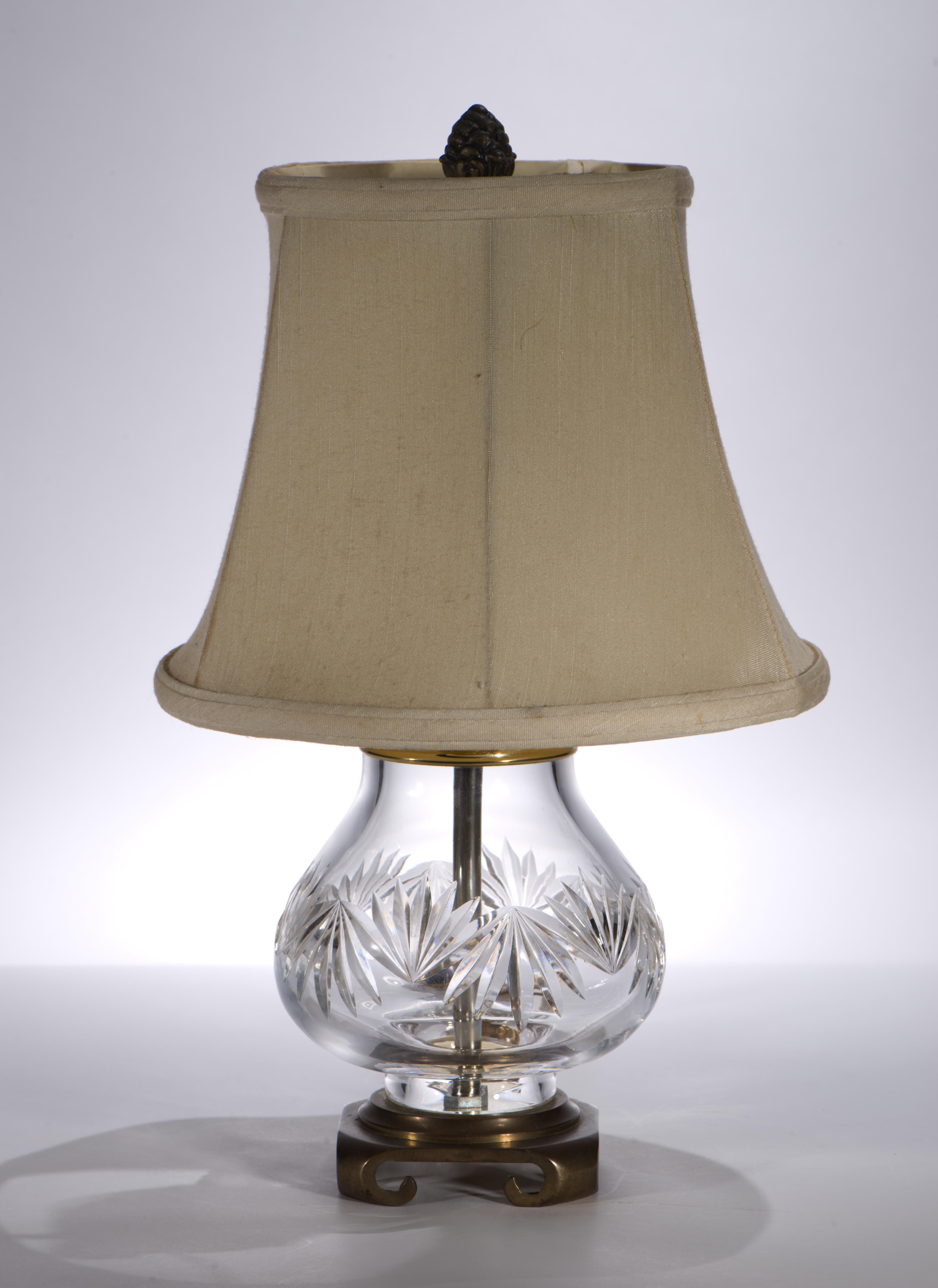 Vintage accent or table lamp features cut crystal base, brass base and topper, and handmade silk shade. The wiring is encased in brass tube, serving as a textured accent in the center of the lamp. The lamp comes with the original finial on clip-on