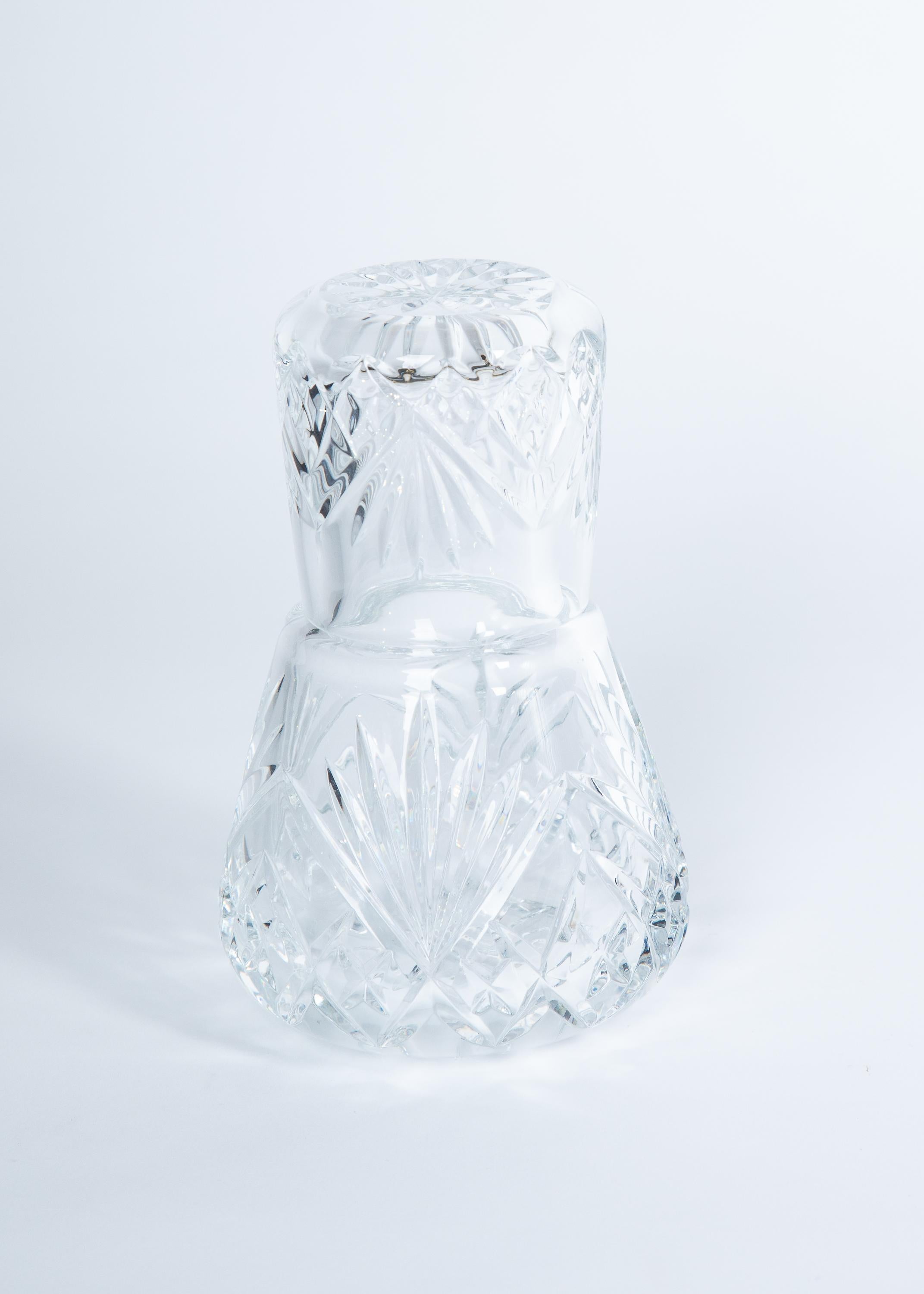 Heavy cut crystal bedside water carafe with tumbler glass top.