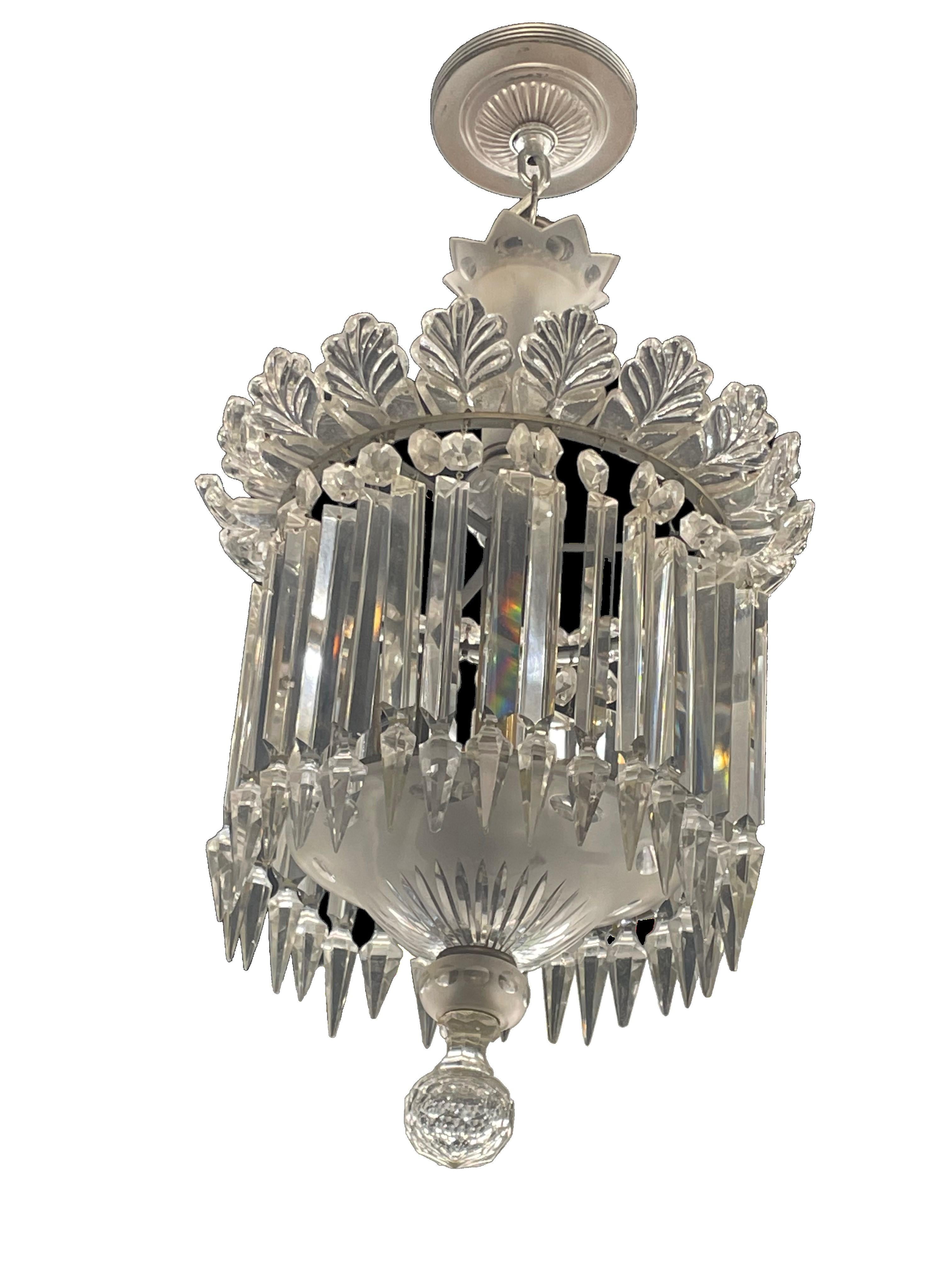 Slim Waterford Lustre crystals hang in a tight-knit, layered configuration, reminiscent of a wedding cake. A trim chandelier that adds simple elegance to any room.