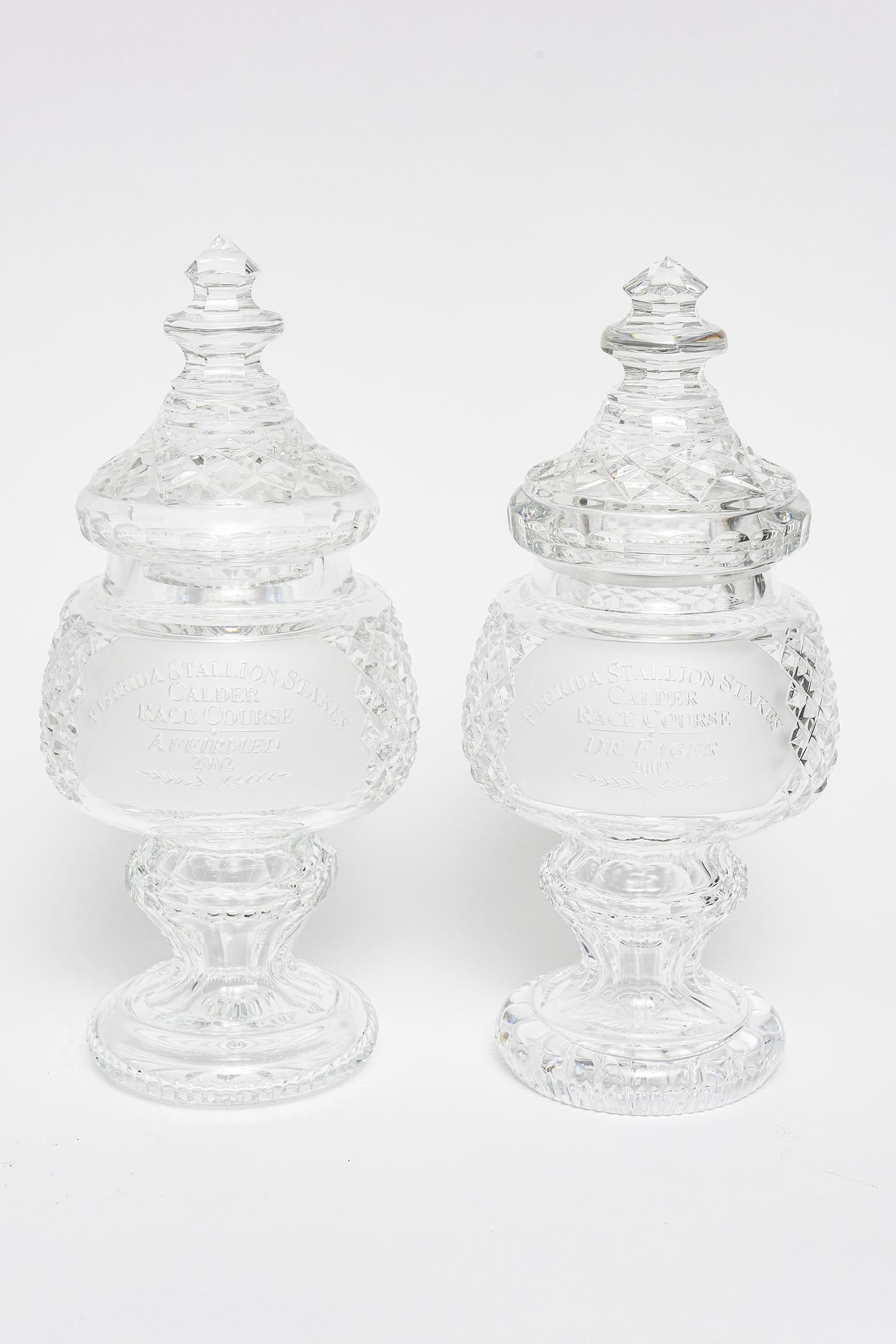 Group of 4 Waterford cut glass lead crystal horse racing trophies.
The group included one tall jar, a vase and a pair of smaller jars.
All 4 pieces are signed Waterford on the bottom.

Tallest lidded jar or apothecary jar has an etched horse