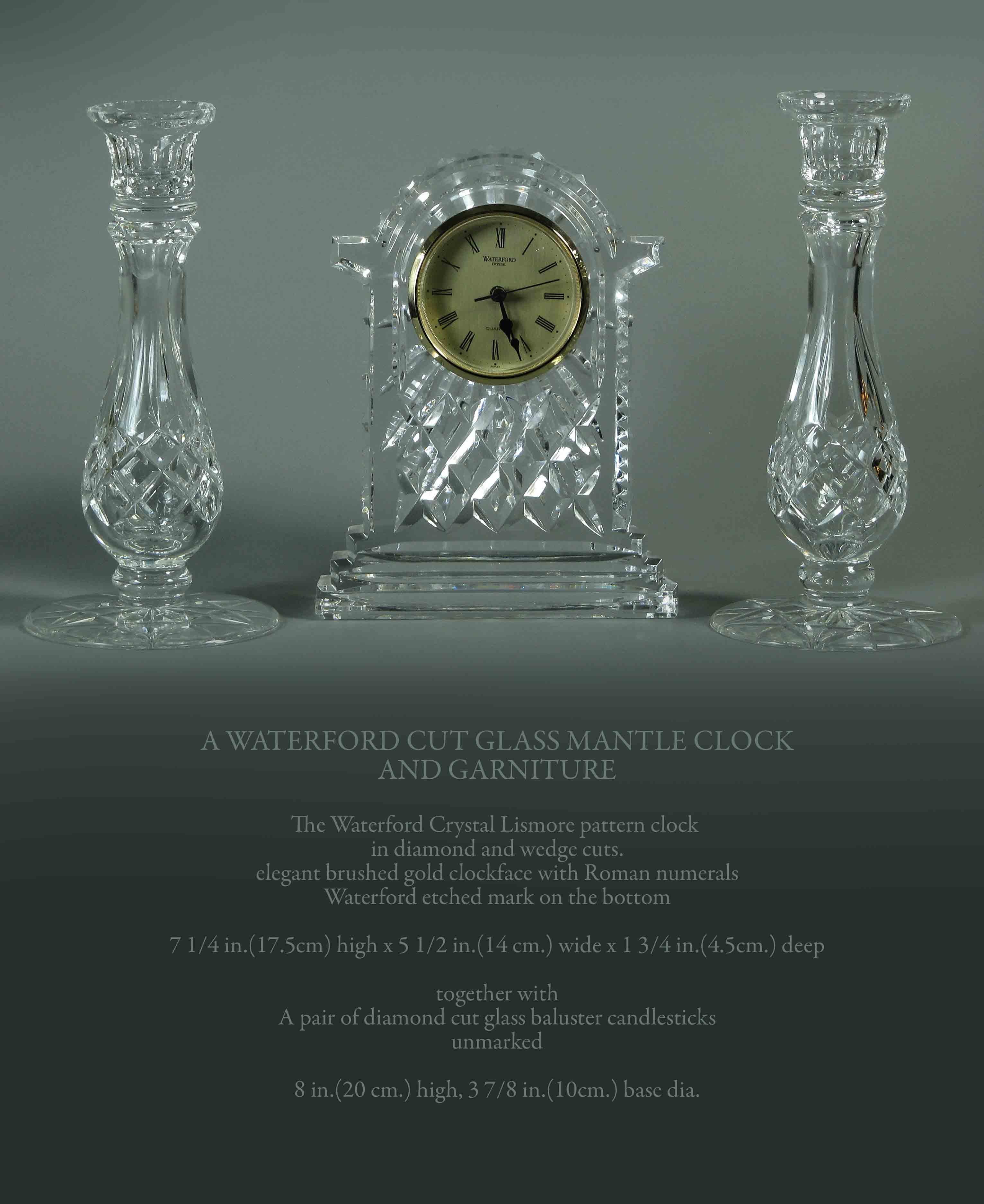 A WATERFORD CUT GLASS MANTLE CLOCK
AND GARNITURE

The Waterford Crystal Lismore pattern clock 
in diamond and wedge cuts.
elegant brushed gold clockface with Roman numerals
Waterford etched mark on the bottom.

7 1/4 in.(17.5cm) high.
 5