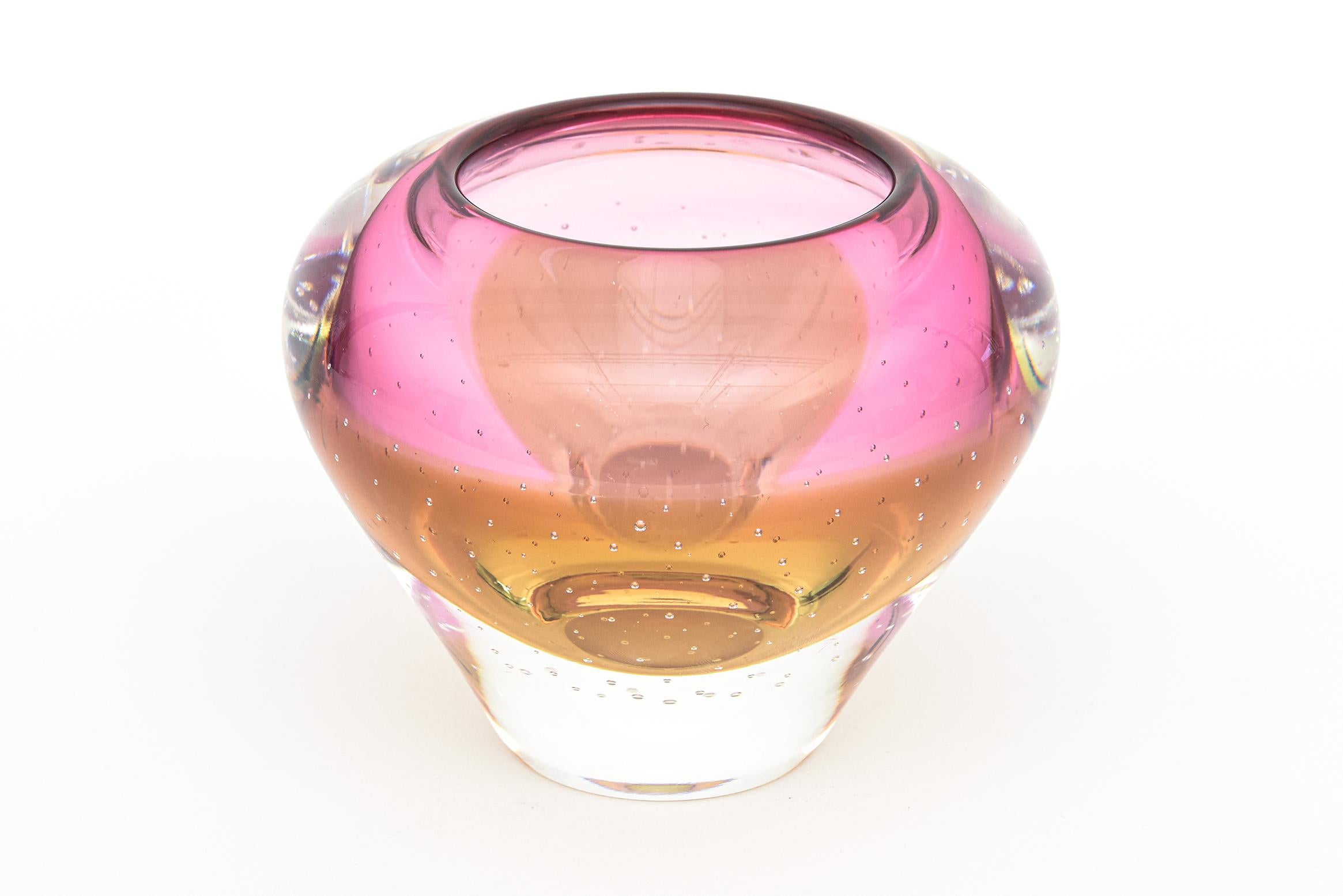This beautiful small crystal vase is made by Waterford and is from the Evolution series. It was produced in Poland as stated on the label. Signed and labeled. From the 1990's.
It has tiny bullecante bubbles with hues of pink to amber to clear. It